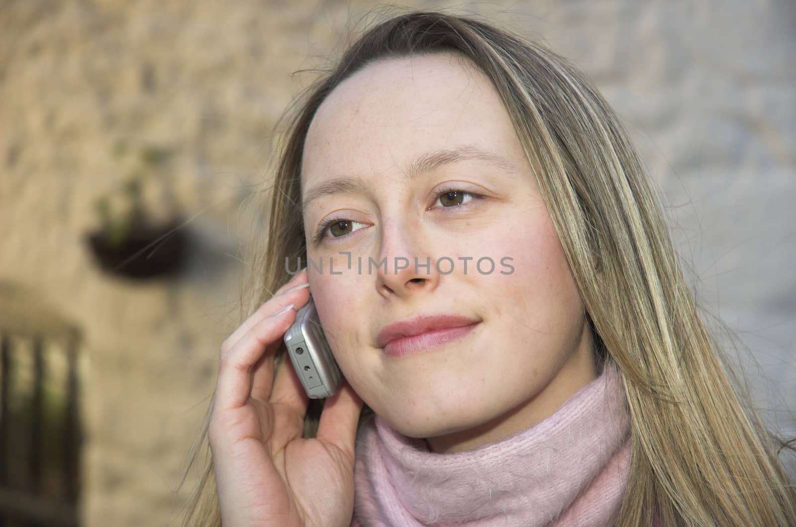 Young woman listening to a her mobile phone.