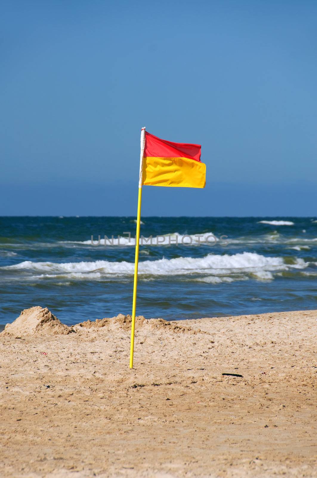 A lifeguard flag on the beach