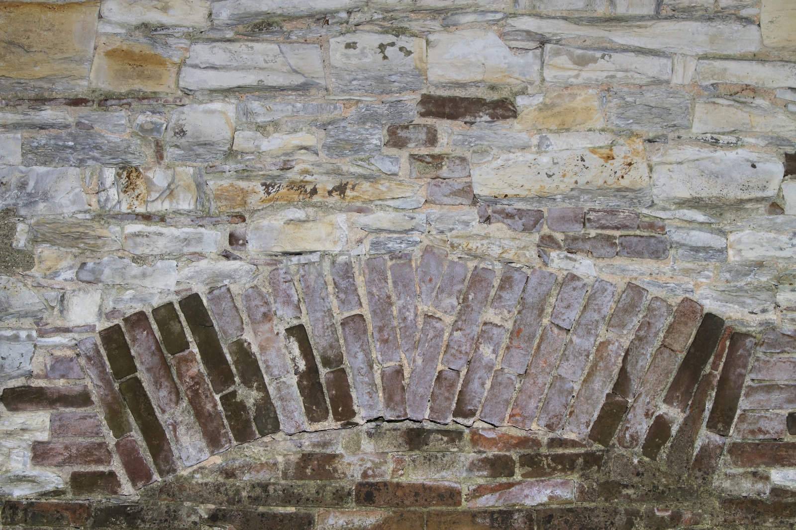 background or texture of a stone wall with brick insertion