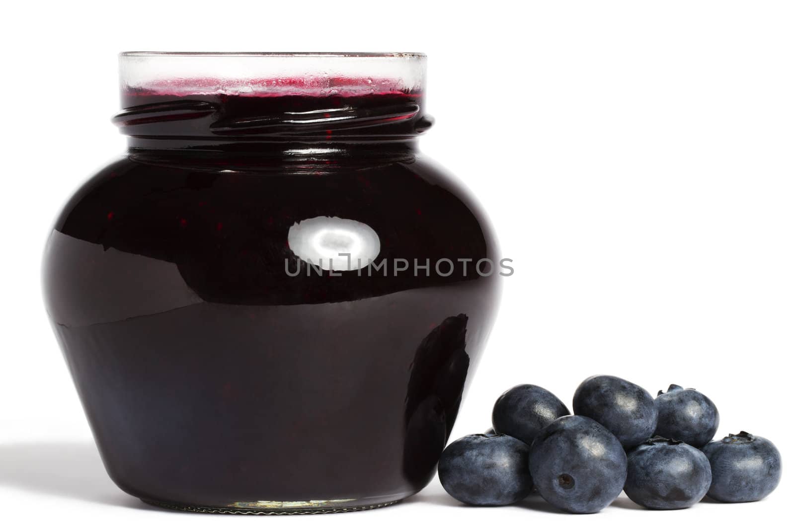 jam jar with blueberry jam and blueberries aside on white background