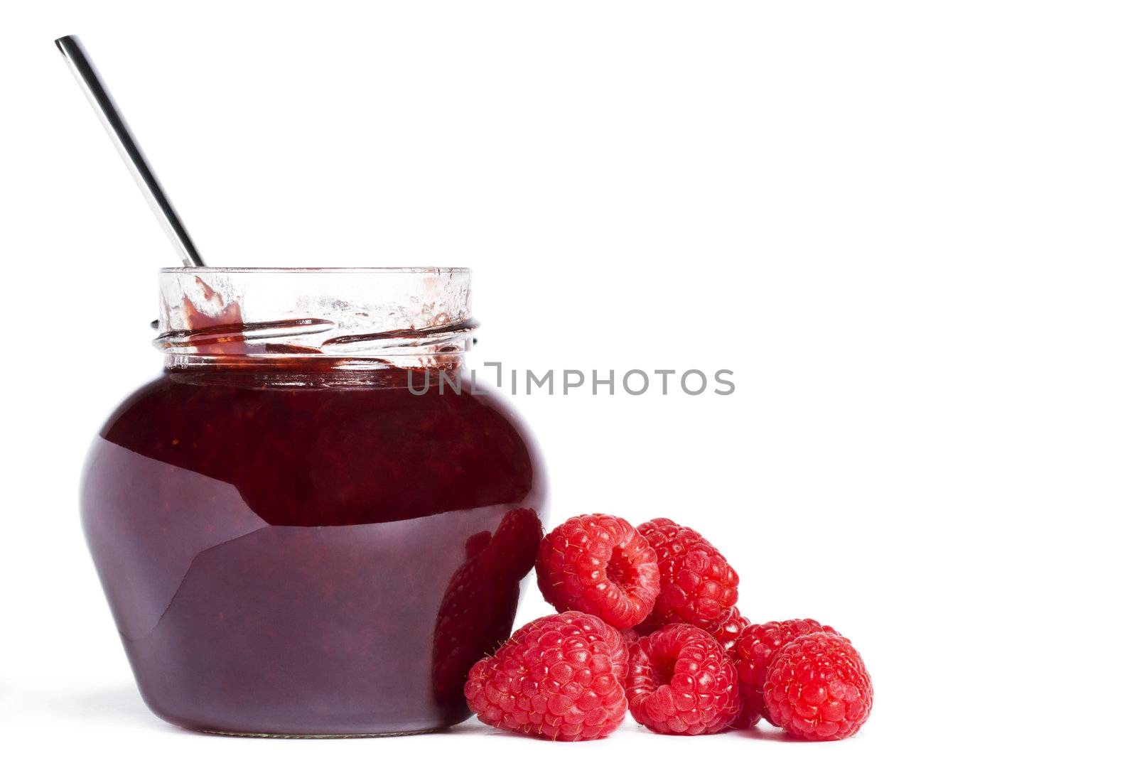  raspberry jam jar with a spoon and raspberries aside on white background