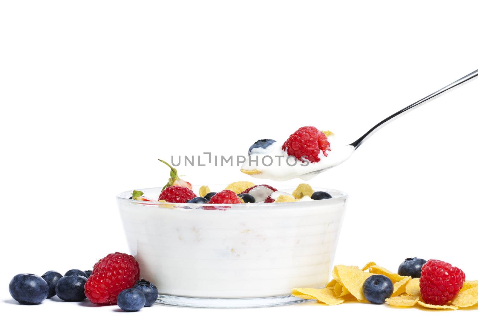 yogurt with blueberries, strawberries, raspberries and cornflakes on white background