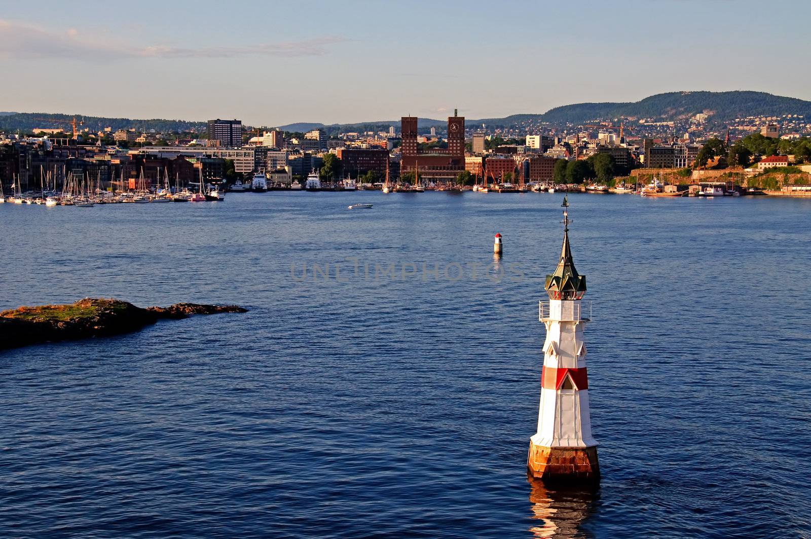 A small lighthouse with Oslo city, Norway in the background