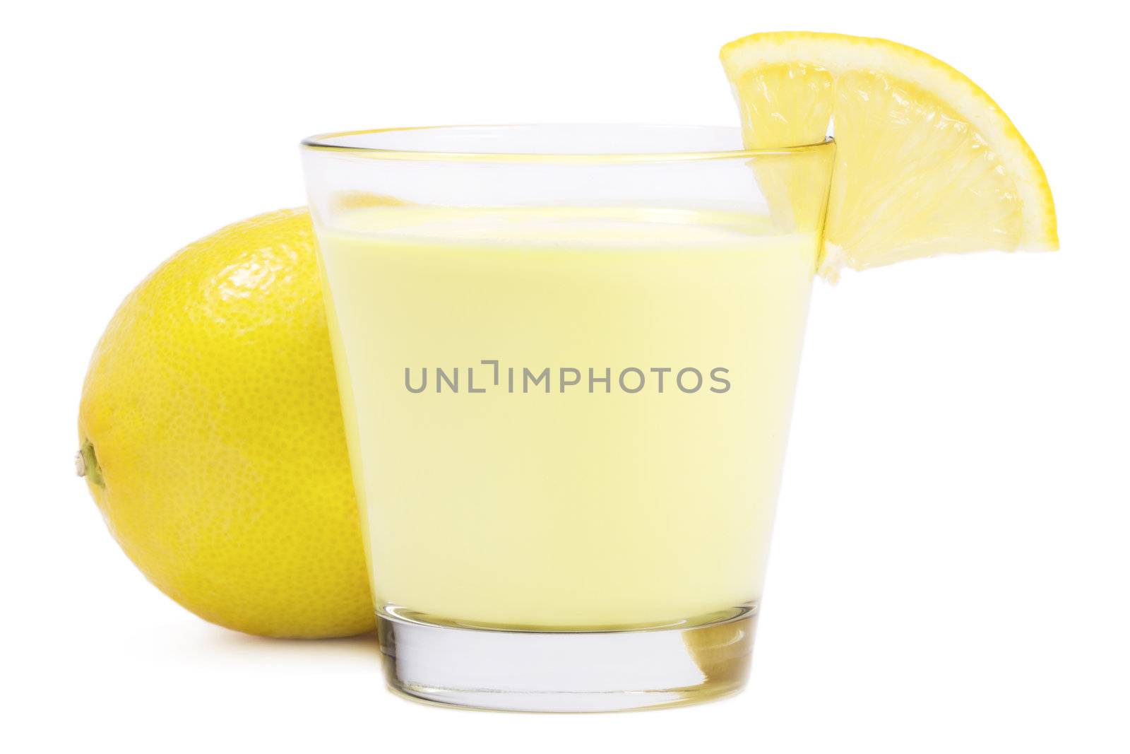 lemon milkshake with a piece of lemon in front of a lemon on white background