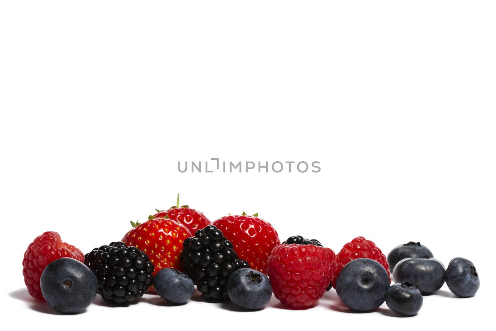 blueberries, strawberries blackberries and raspberries on white background