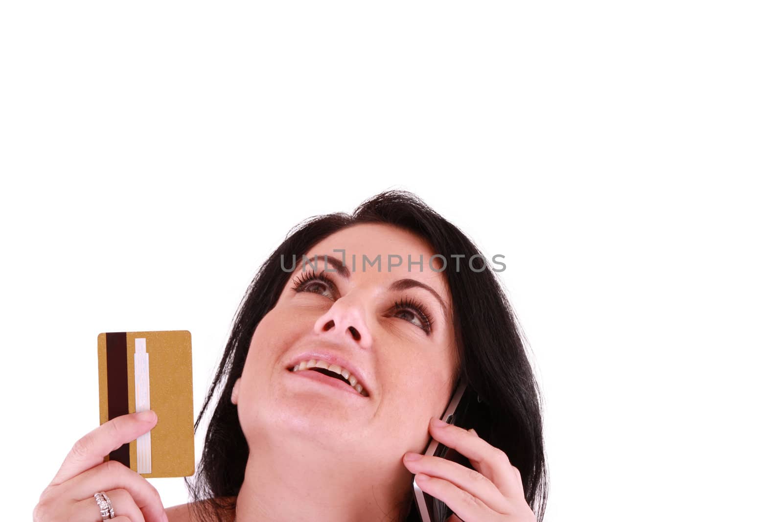 young woman holding credit card looking up