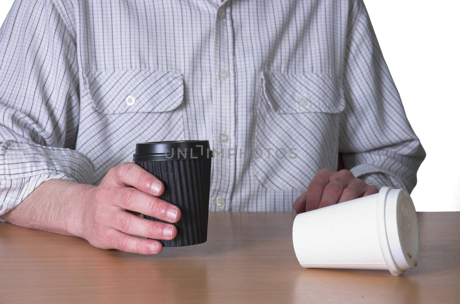 Man sat at desk drinking take away coffee. Isolated on whie background.