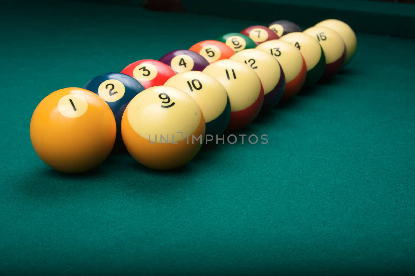 Billiard balls arranged in order from one to fifteen, shallow depth of field