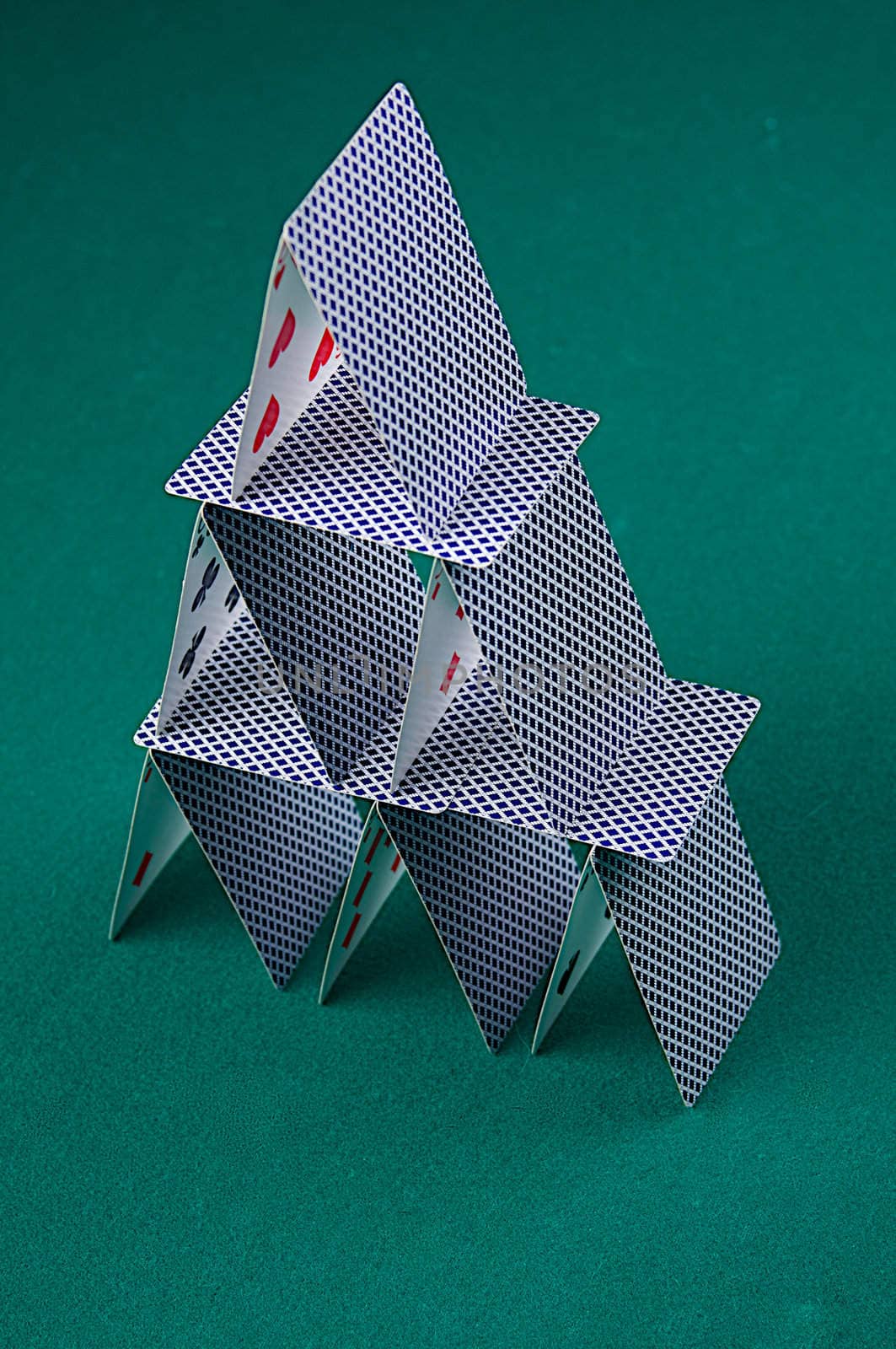 A house of cards on green felt