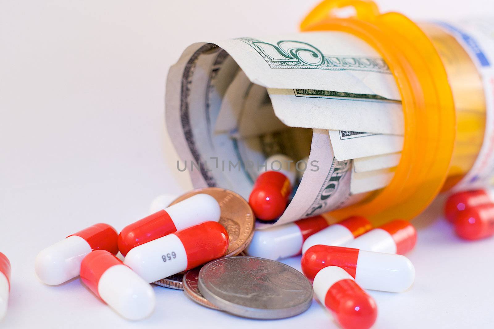 Prescription drugs spill from an orange pill bottle filled with money