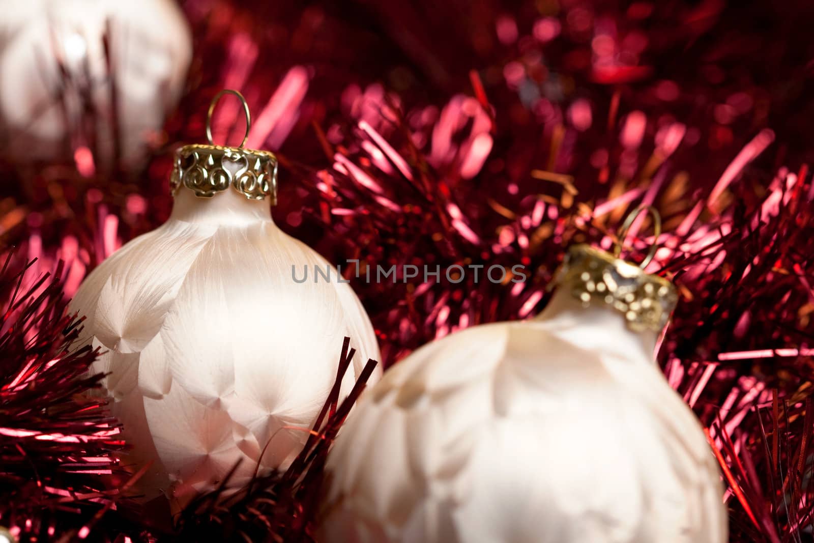 a set of christmas balls on a red underground and before golden background