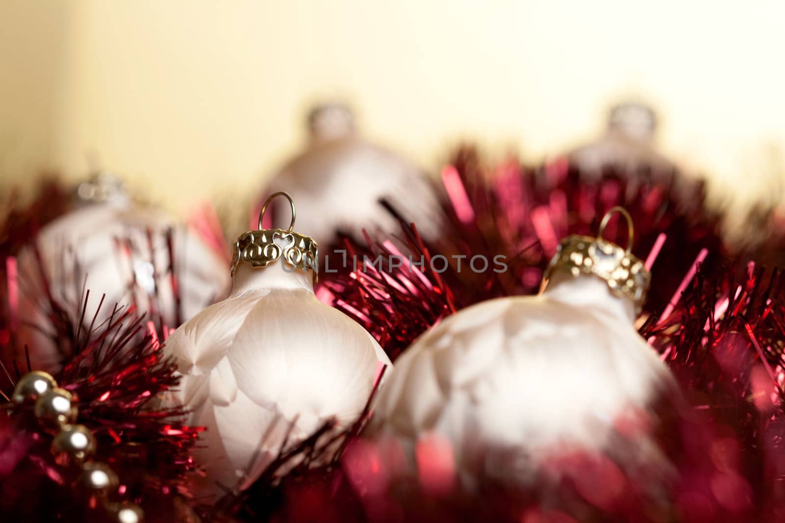 a set of christmas balls on a red underground and before golden background