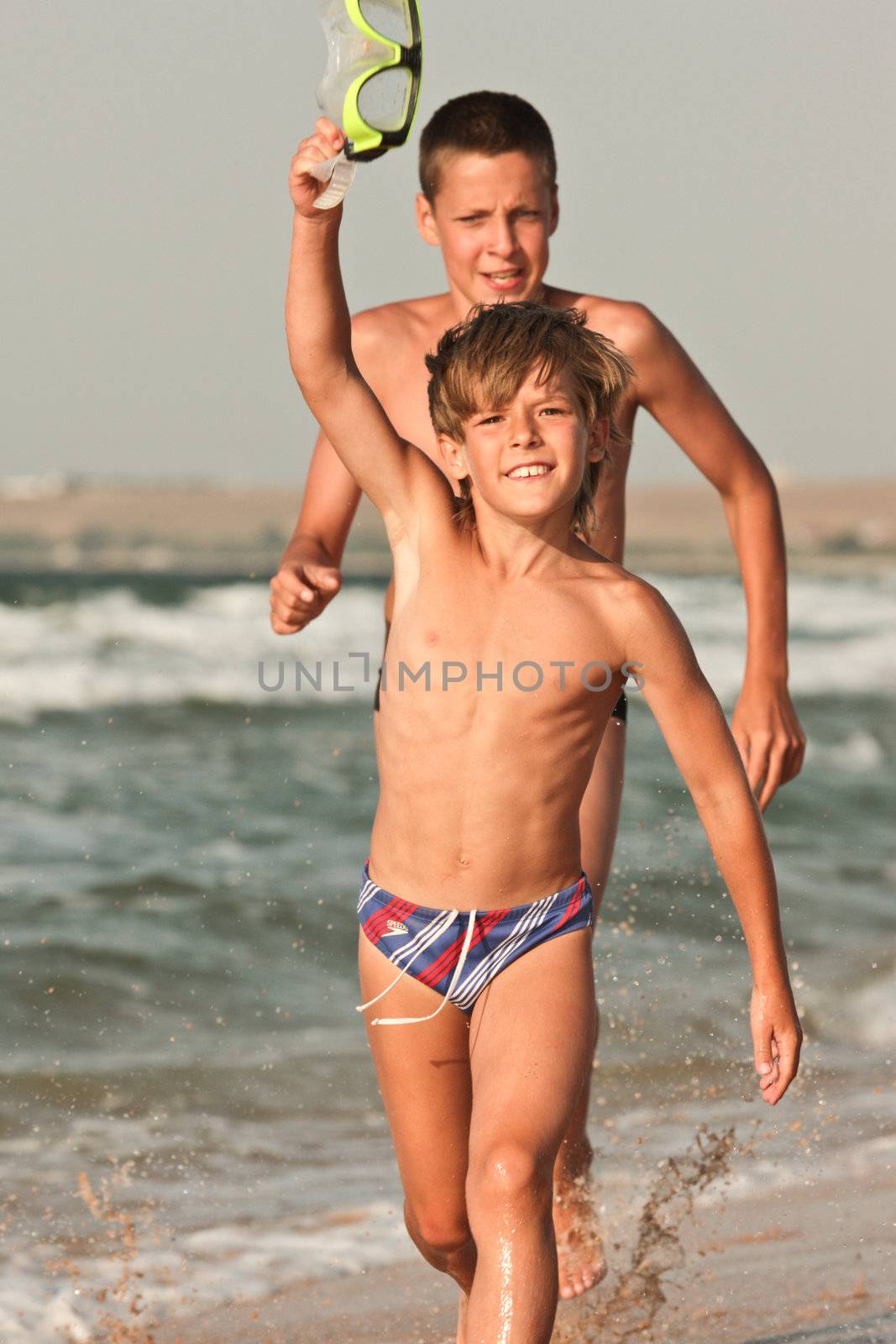 people series: two brother are play the game on sea beach