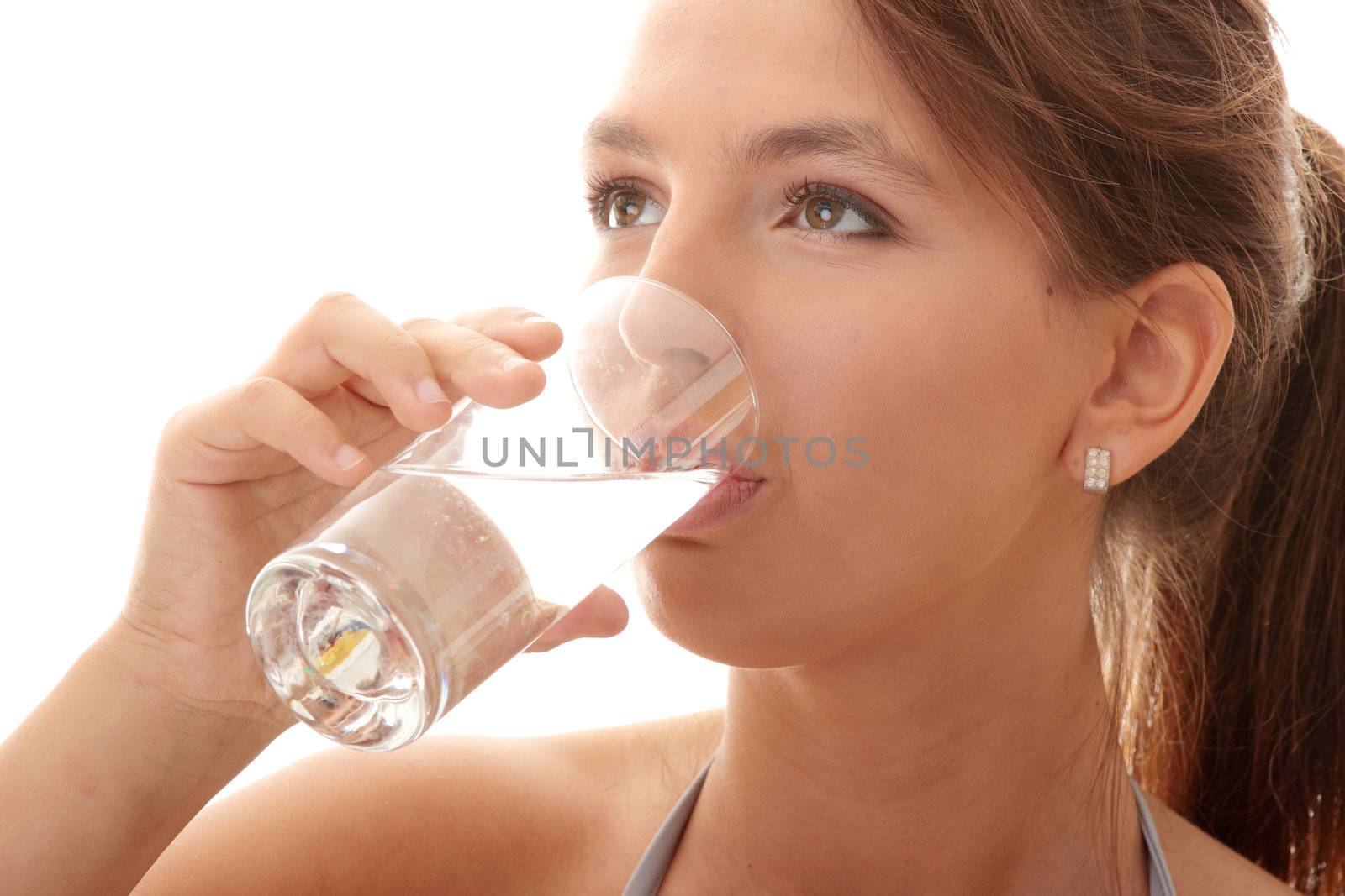 Young woman drinking fresh cold water from glass - isolated on white