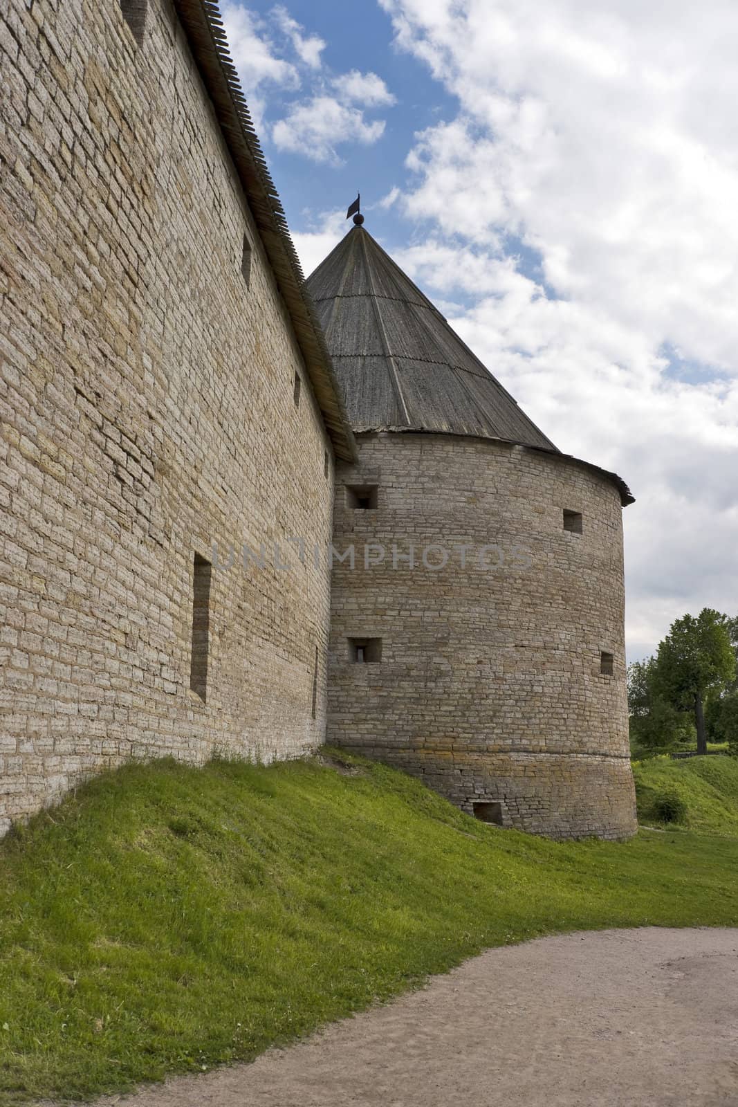 Old fortress tower and wall with portholes