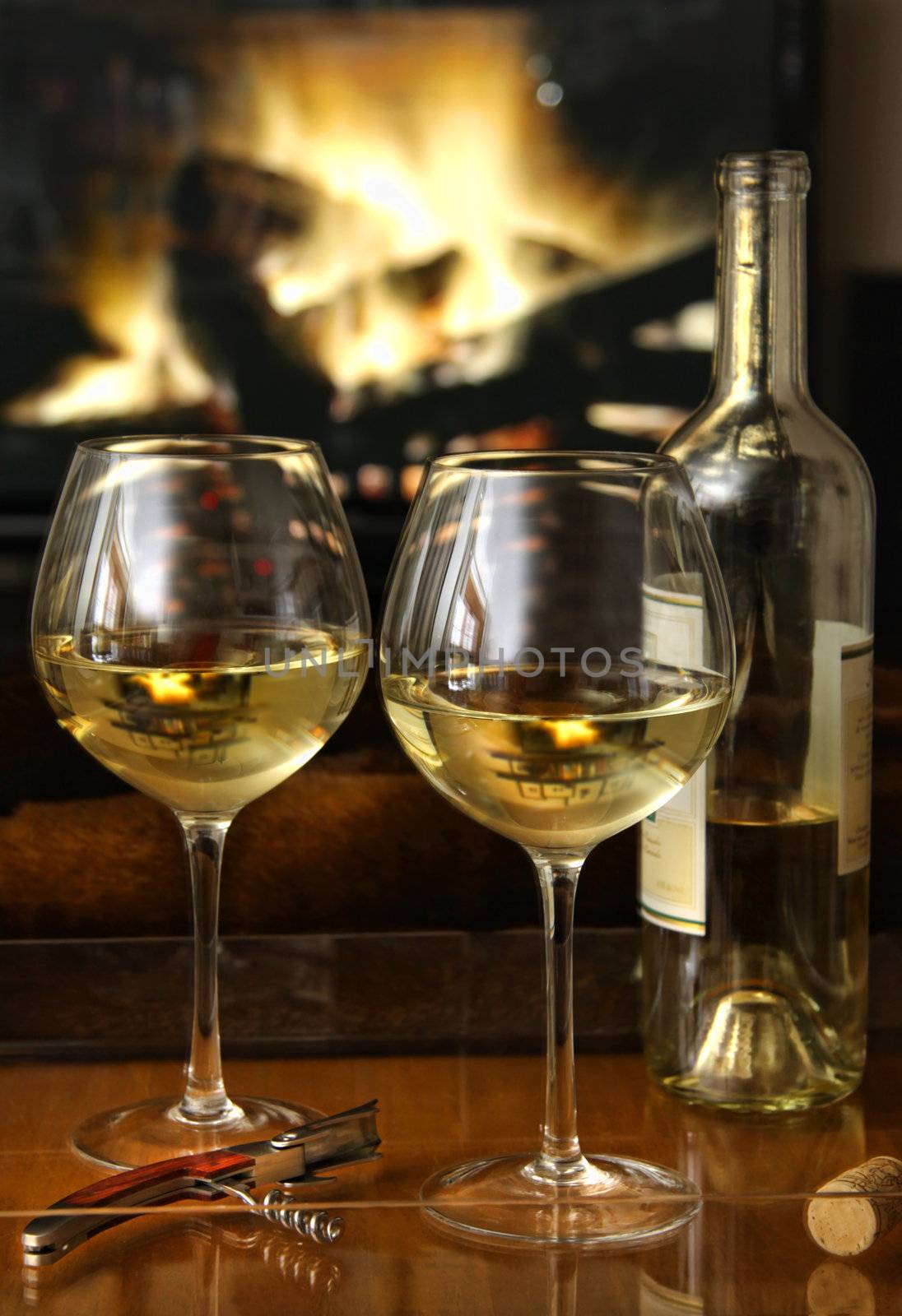 White wine in front of a warm fire by Sandralise