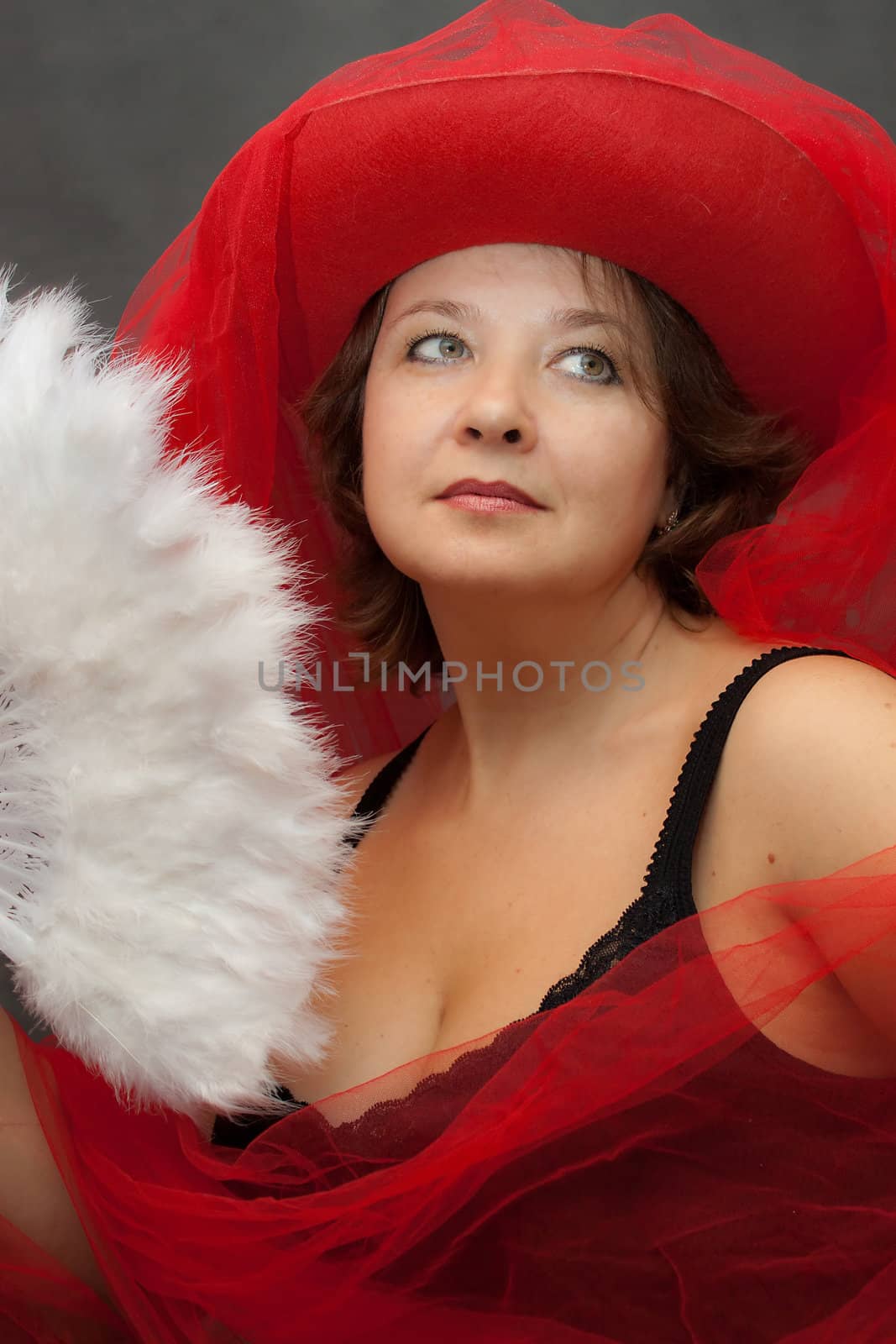 We see Woman in red hat with white fan