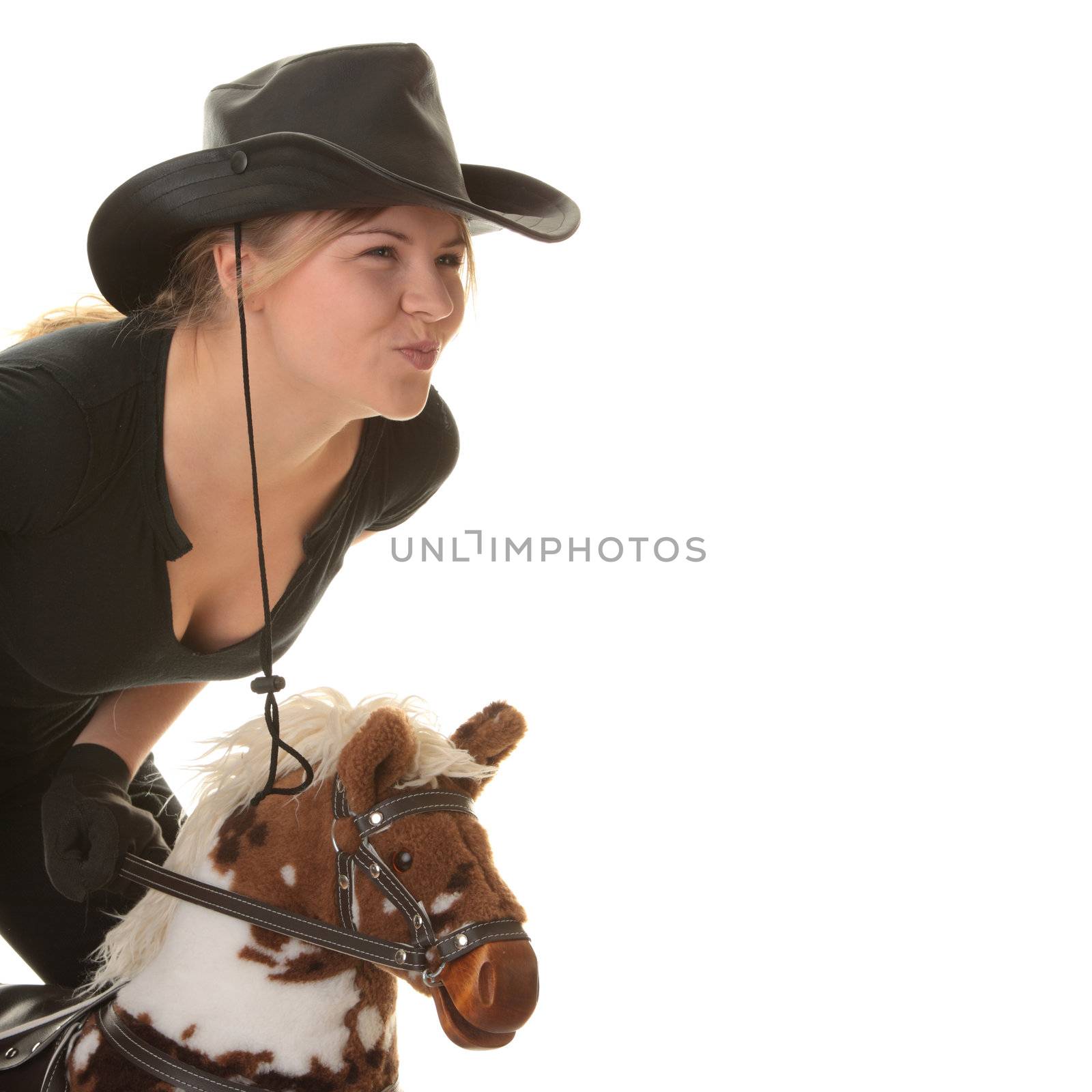 Young beautiful cowgirl (jockey) race on hobbyhorse with face expression isolated on white background (race concept).