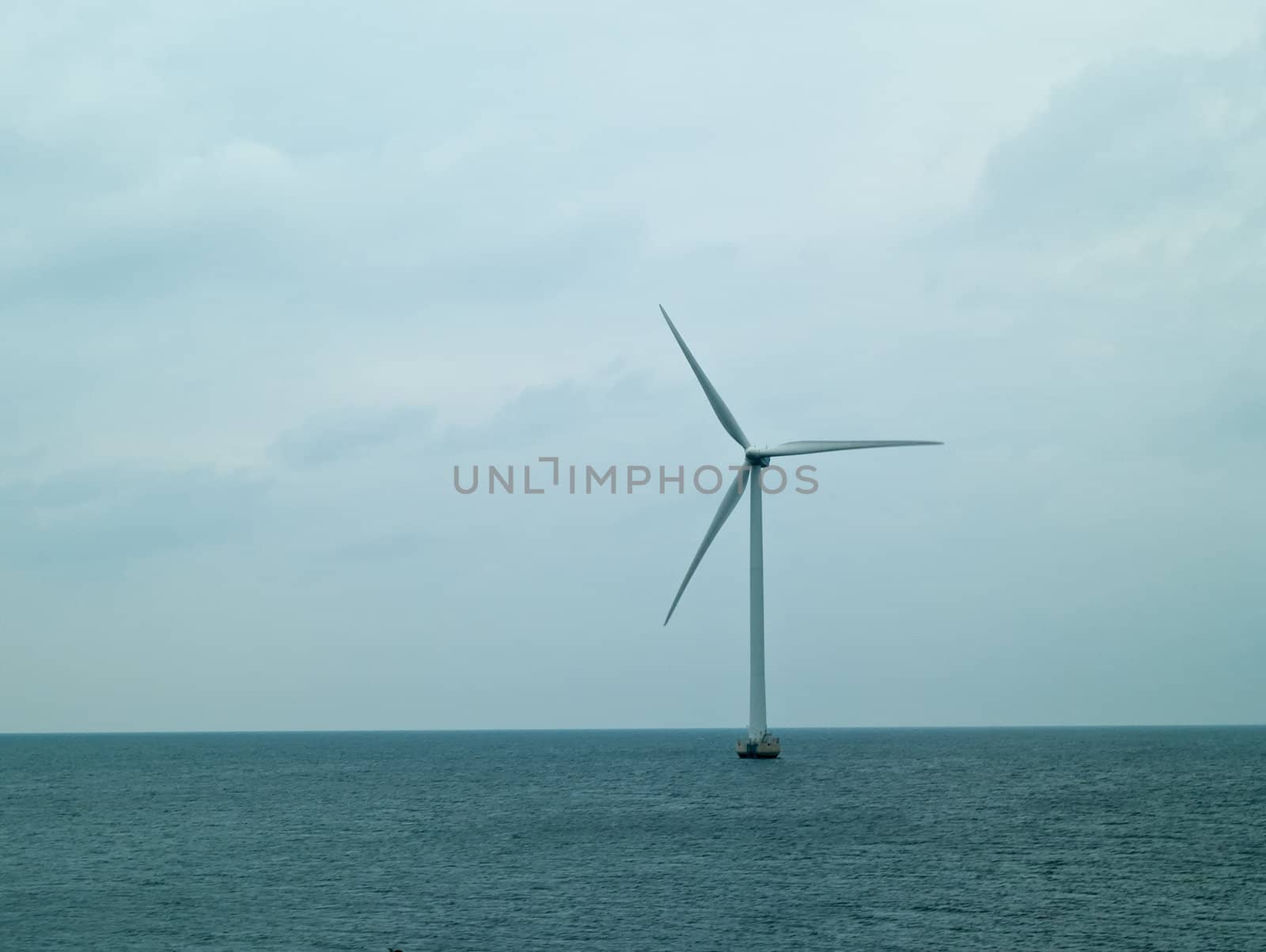 Alternative energy  huge wind mill in the sea generating electricity from nature