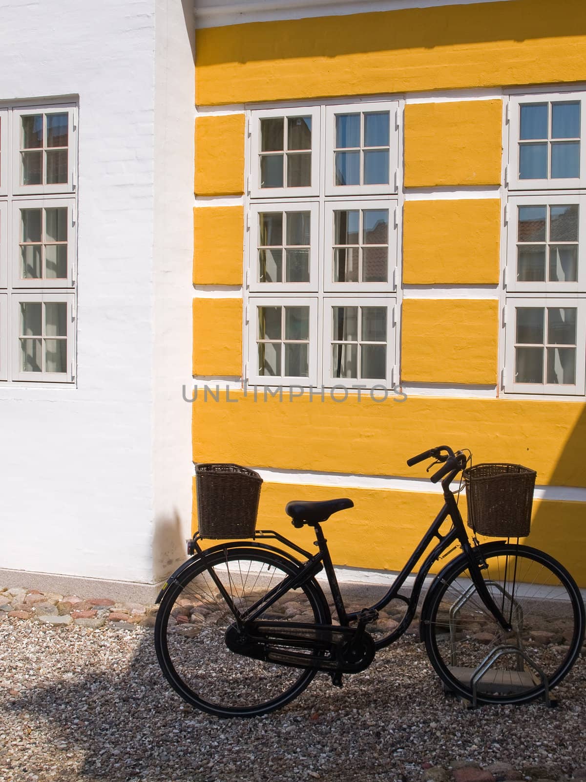 Old retro bicycle parking by a wall  by Ronyzmbow