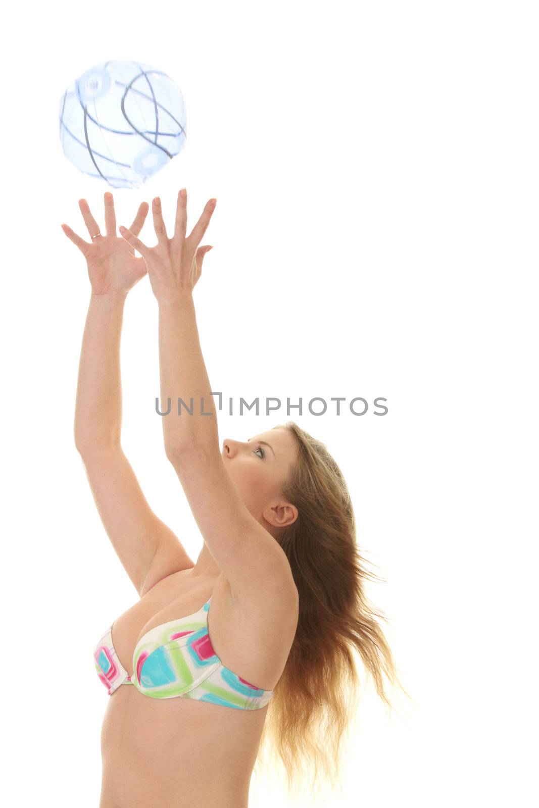 Young beautiful woman catching a beach ball by BDS