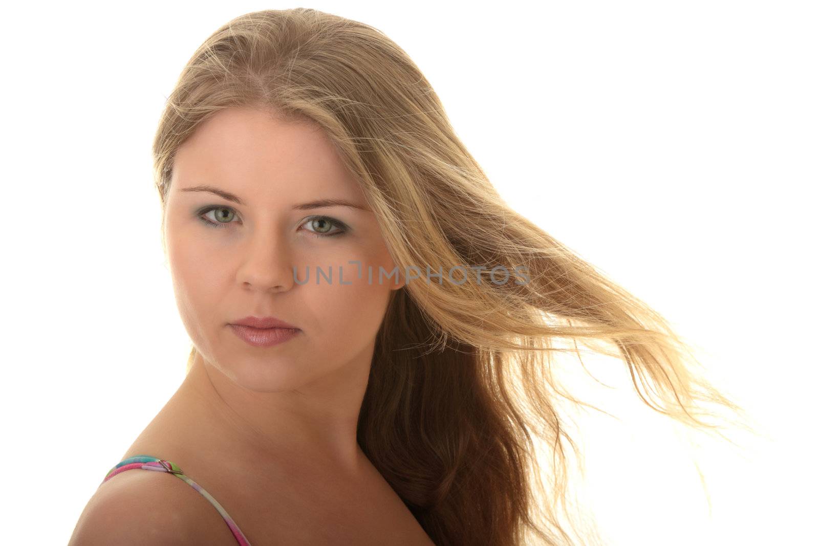 Beautiful girl in black bikini with wind in her hairs isolated on a white background
