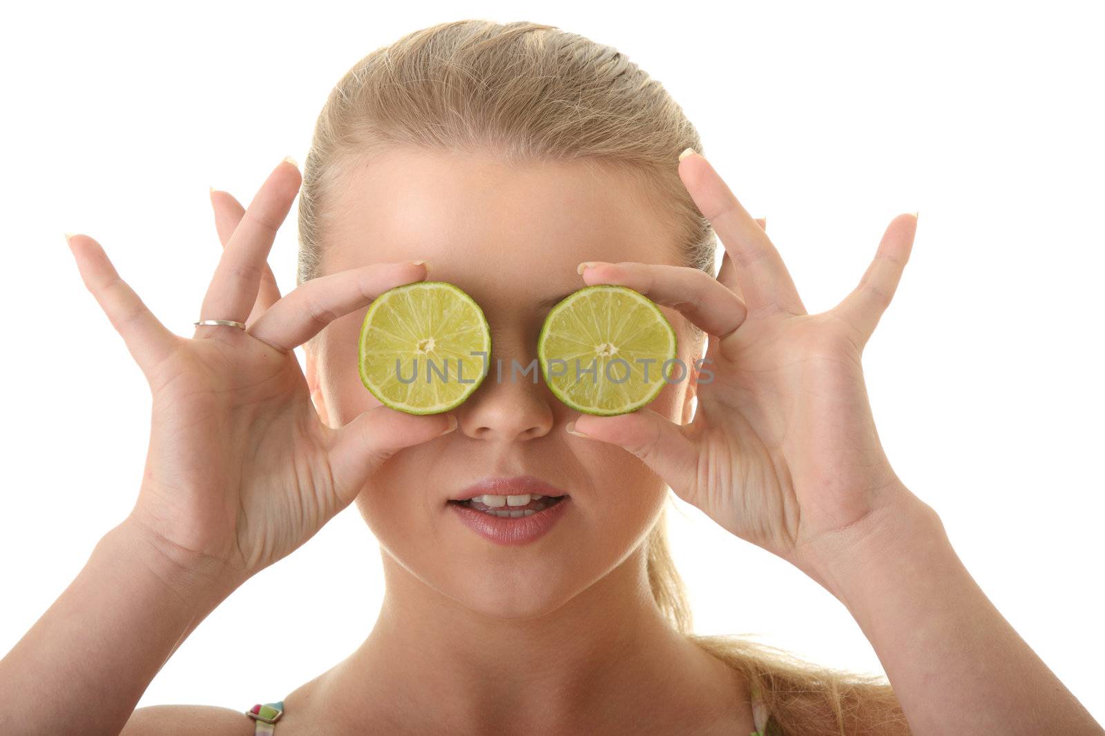 Young woman holding a slices of lime in front of her eyes isolated on white background