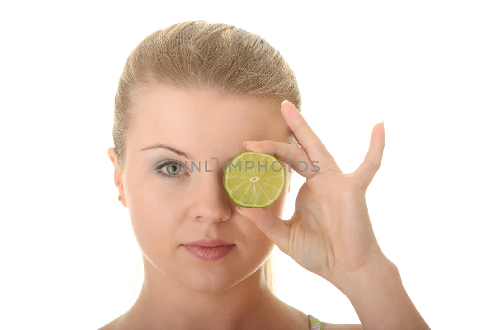 Young woman holding a slice of lemon in front of her eye by BDS