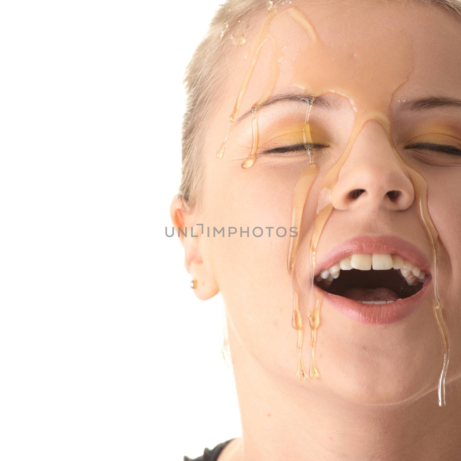 Beautiful young woman with honey on her face by BDS