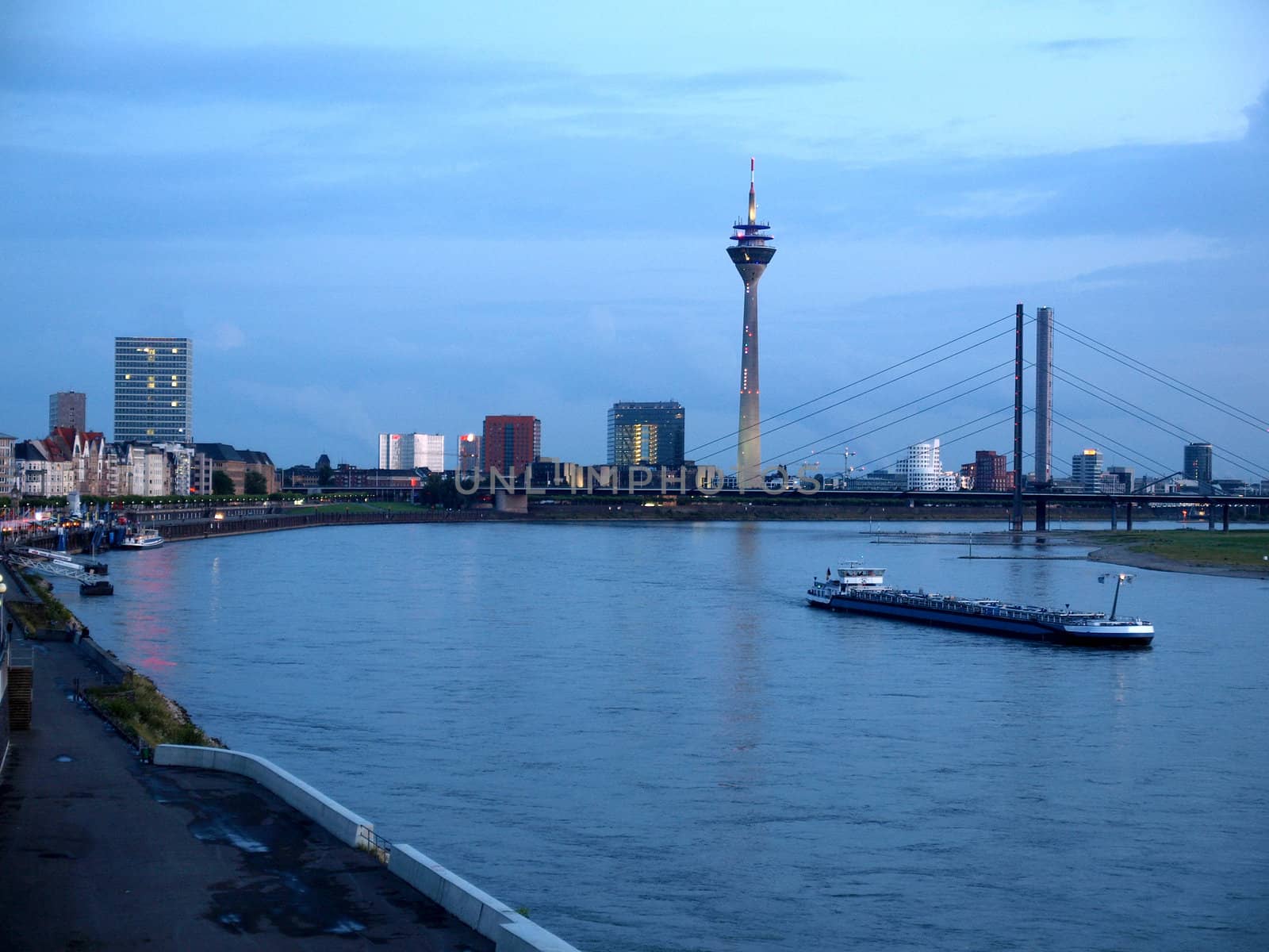 Duesseldorf skyline at night with Rheinturm and river