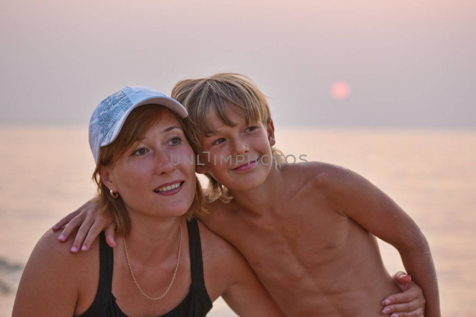 people series: mother an d his son on a sunset beach
