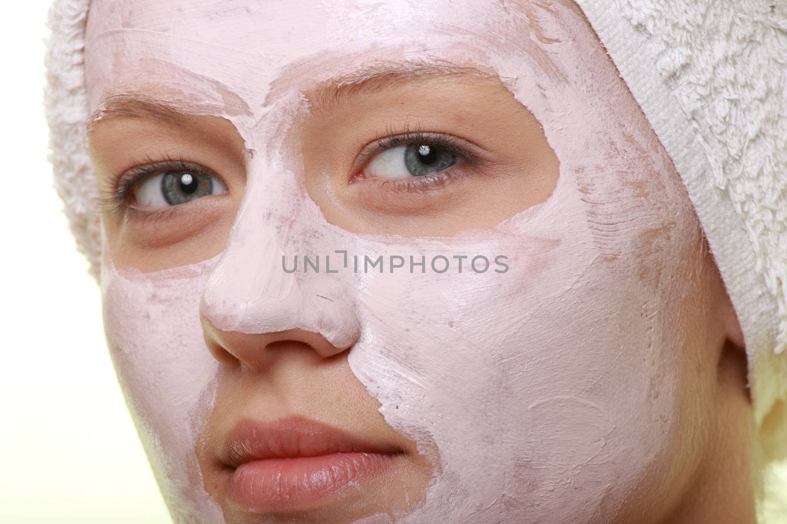 Portrait of a styled model with facial cream mask.