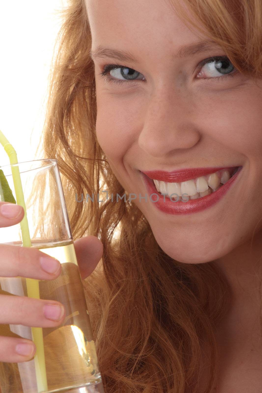 Young beautiful blond woman sipping cocktail (green ice tea) over white background