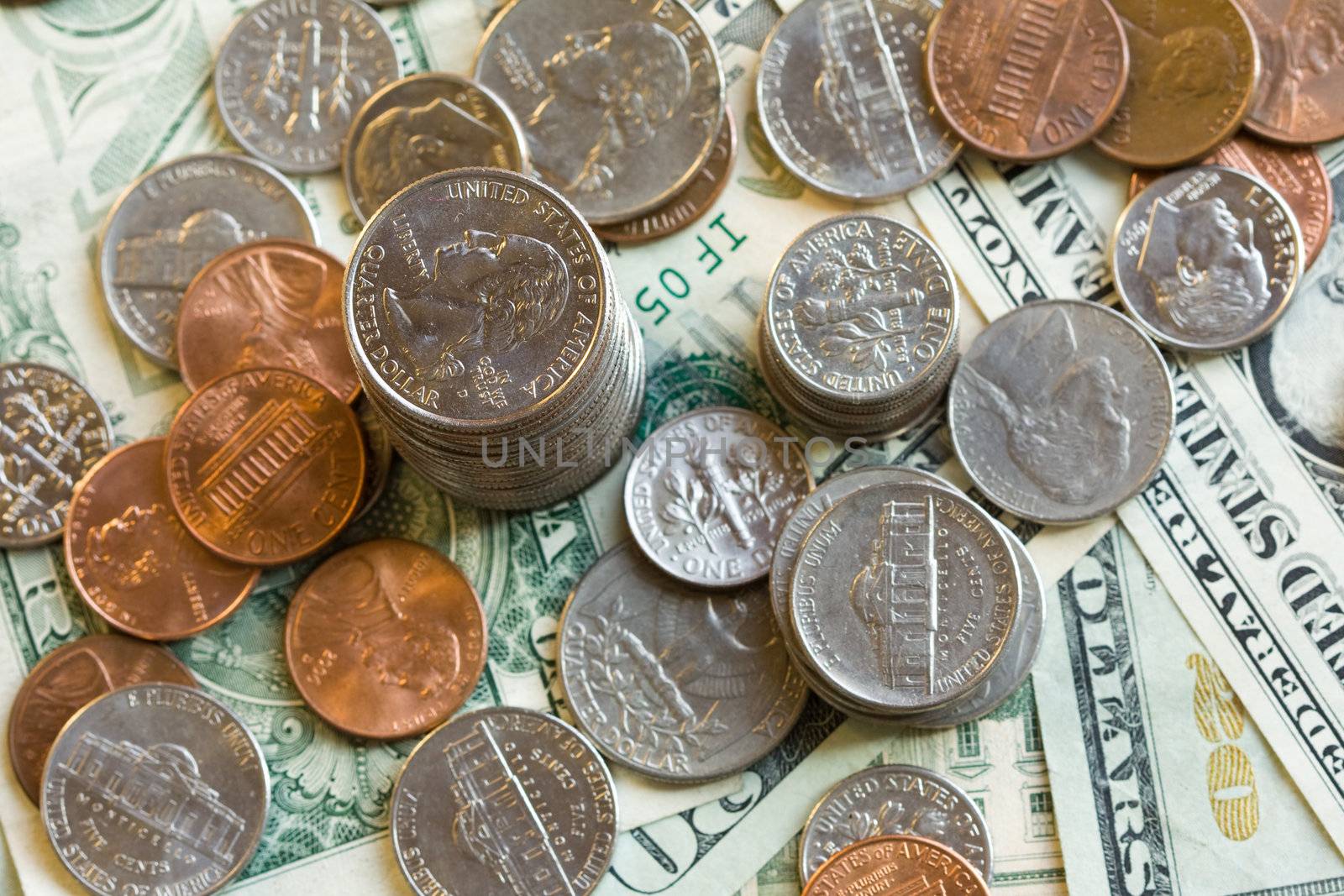 Detail of US dollars and coins with focus on quarter coin