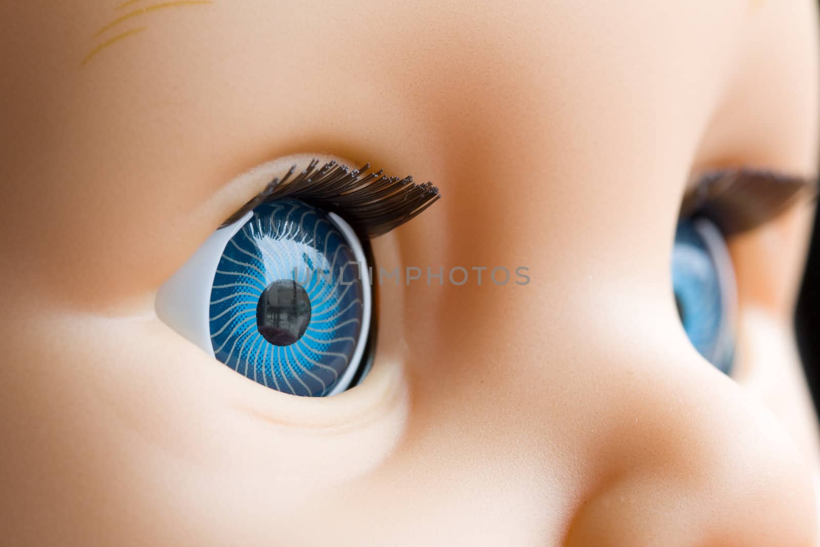 Close uo of a doll eyes with the focus on the right eye