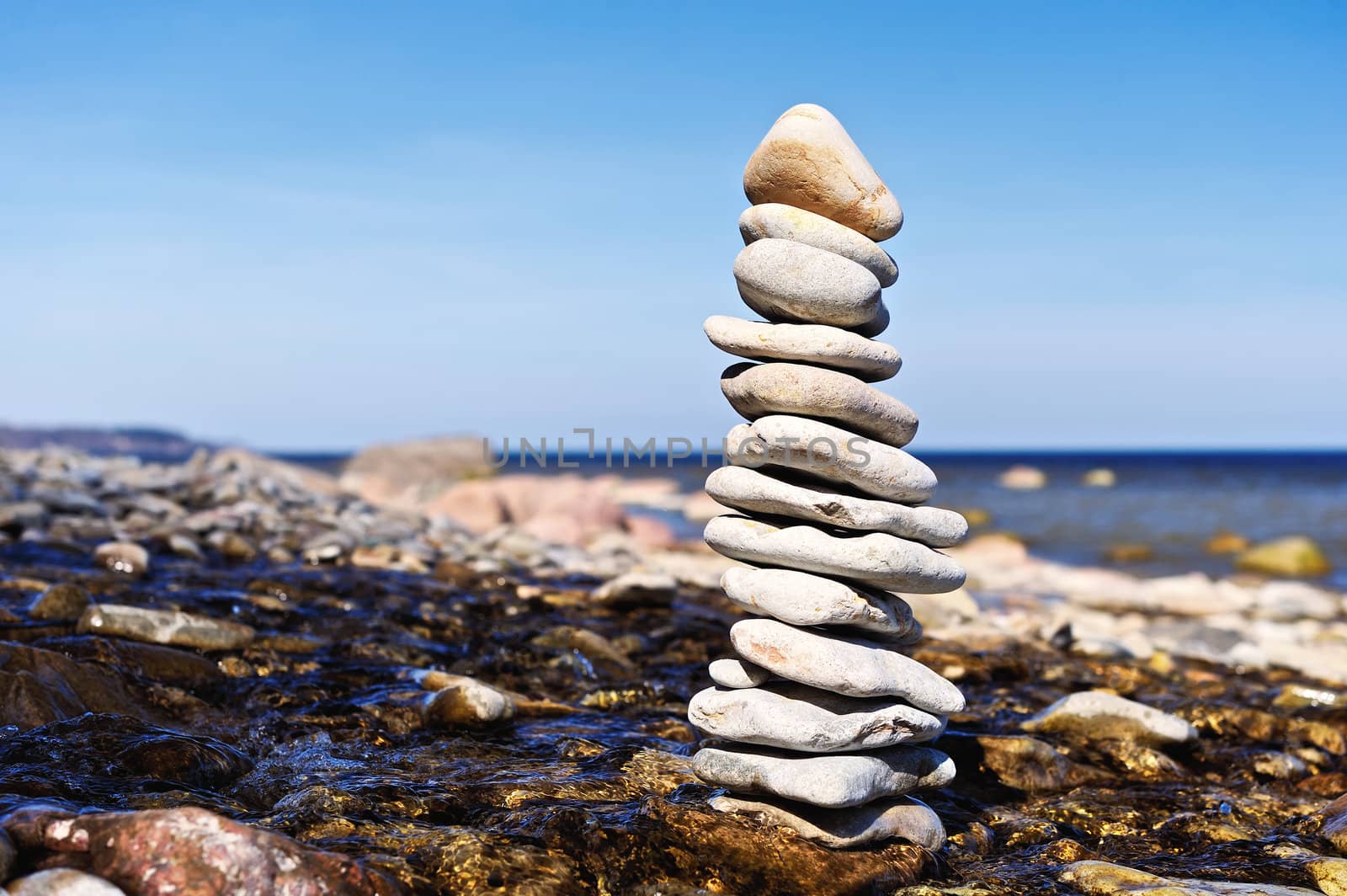 Stack of gravel among the stream on coastline