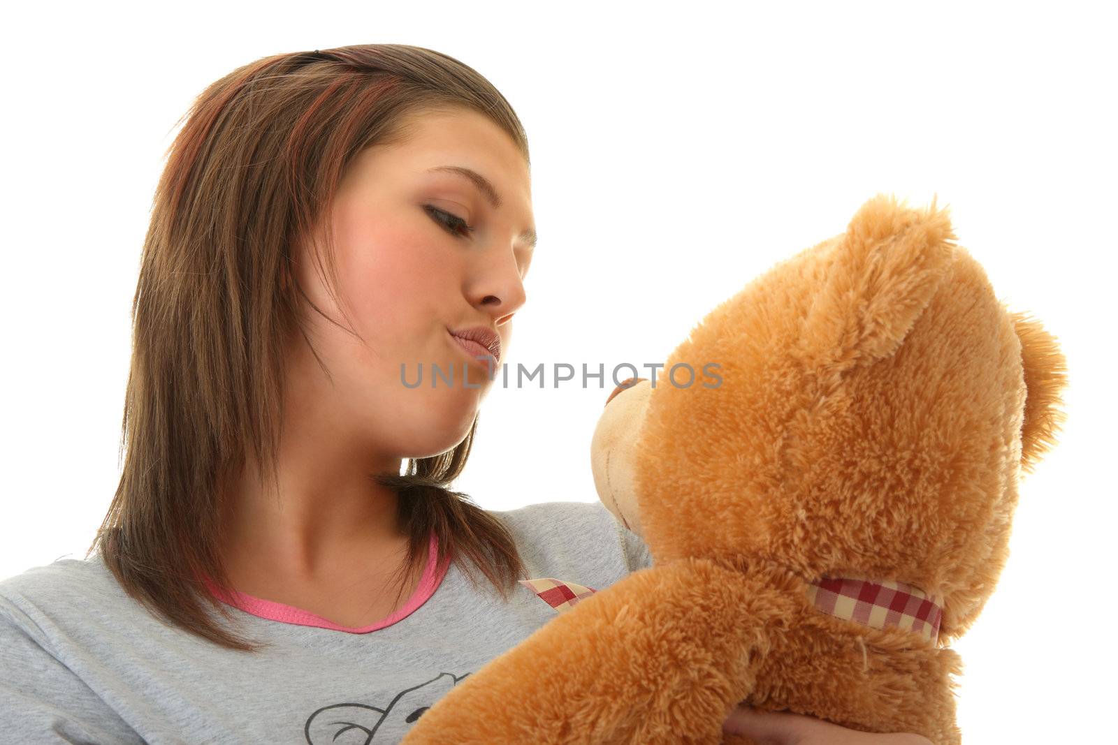 Beautiful teenager holding a teddy bear - isolated on white background