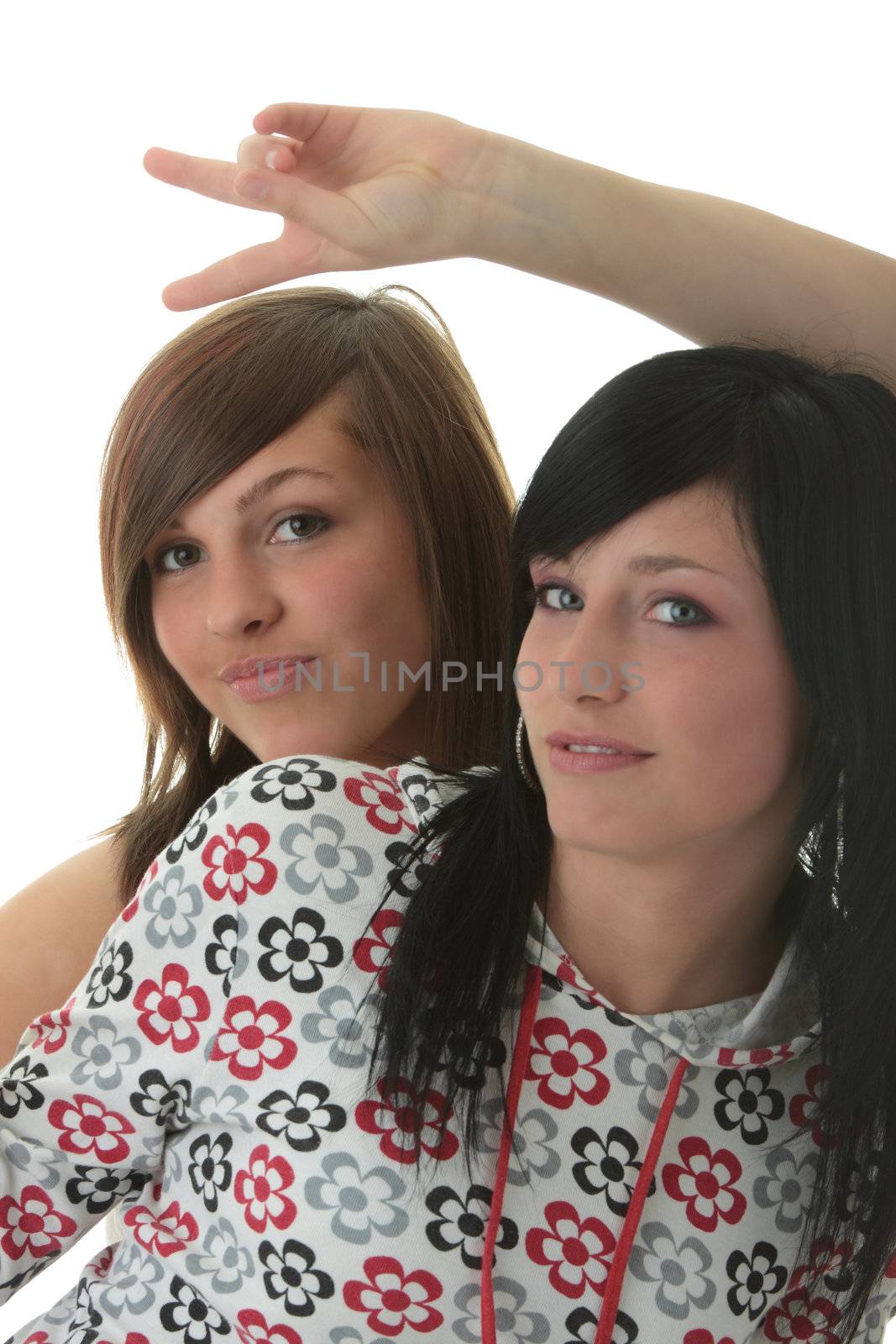 Studio shot of two beautiful happy young woman isolated on white (sisters)