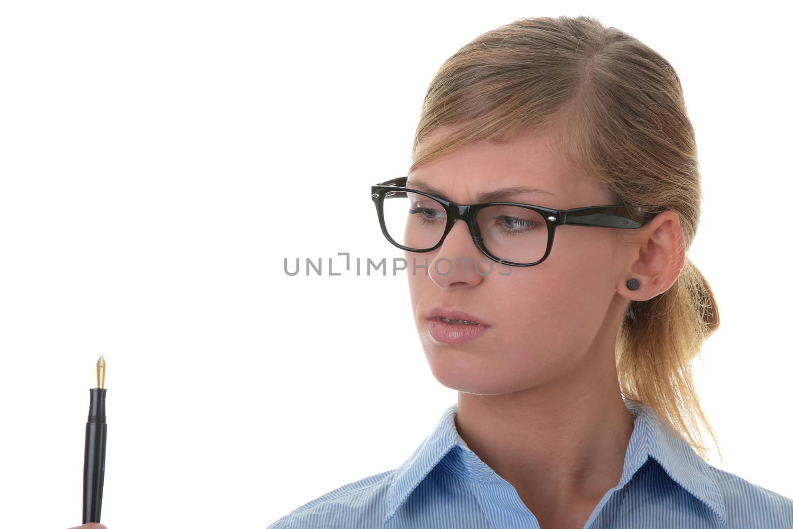 Portrait of a thoughtful young woman in blue shirt holding pen (secretary, student or young businesswoman)