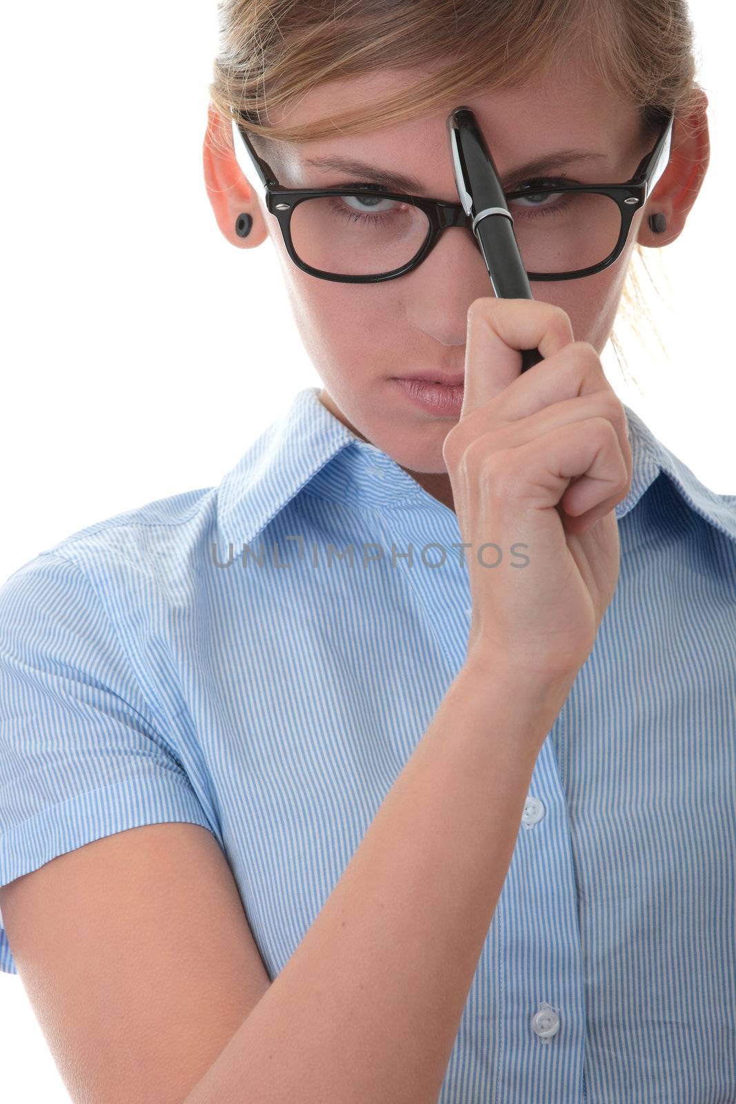 Portrait of a thoughtful young woman in blue shirt holding pen (secretary, student or young businesswoman)