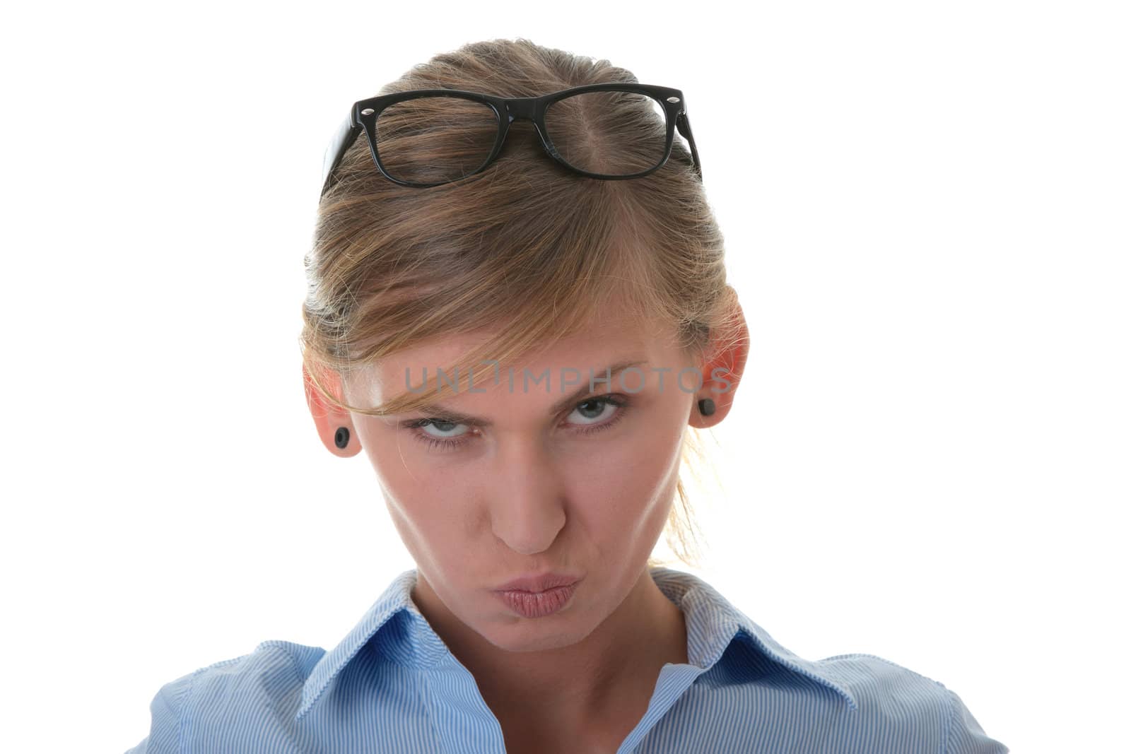 Portrait of a thoughtful young woman in blue shirt and glasses (student, secretary or businesswoman)