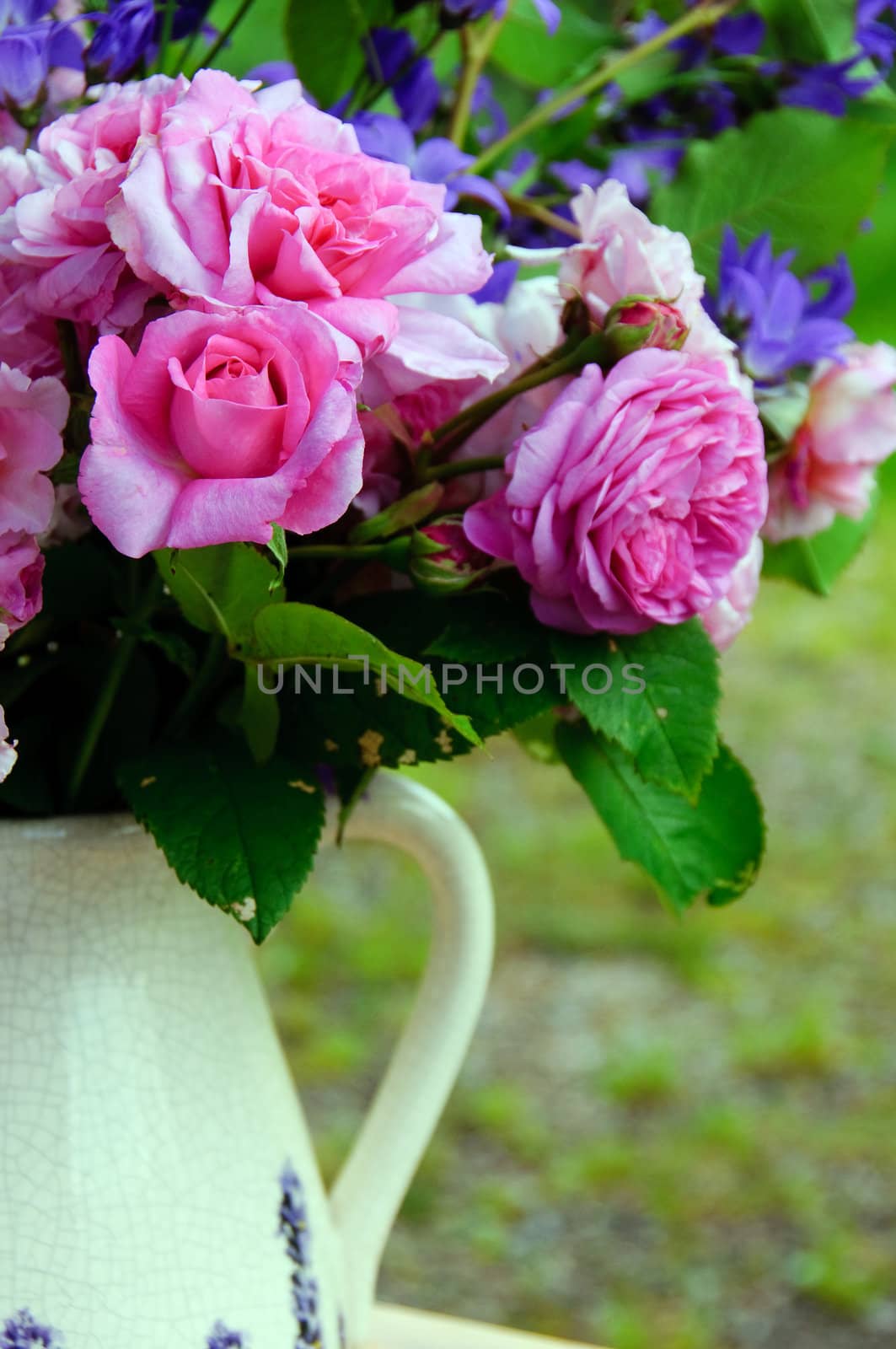 Bouquet of pink roses and bluebells