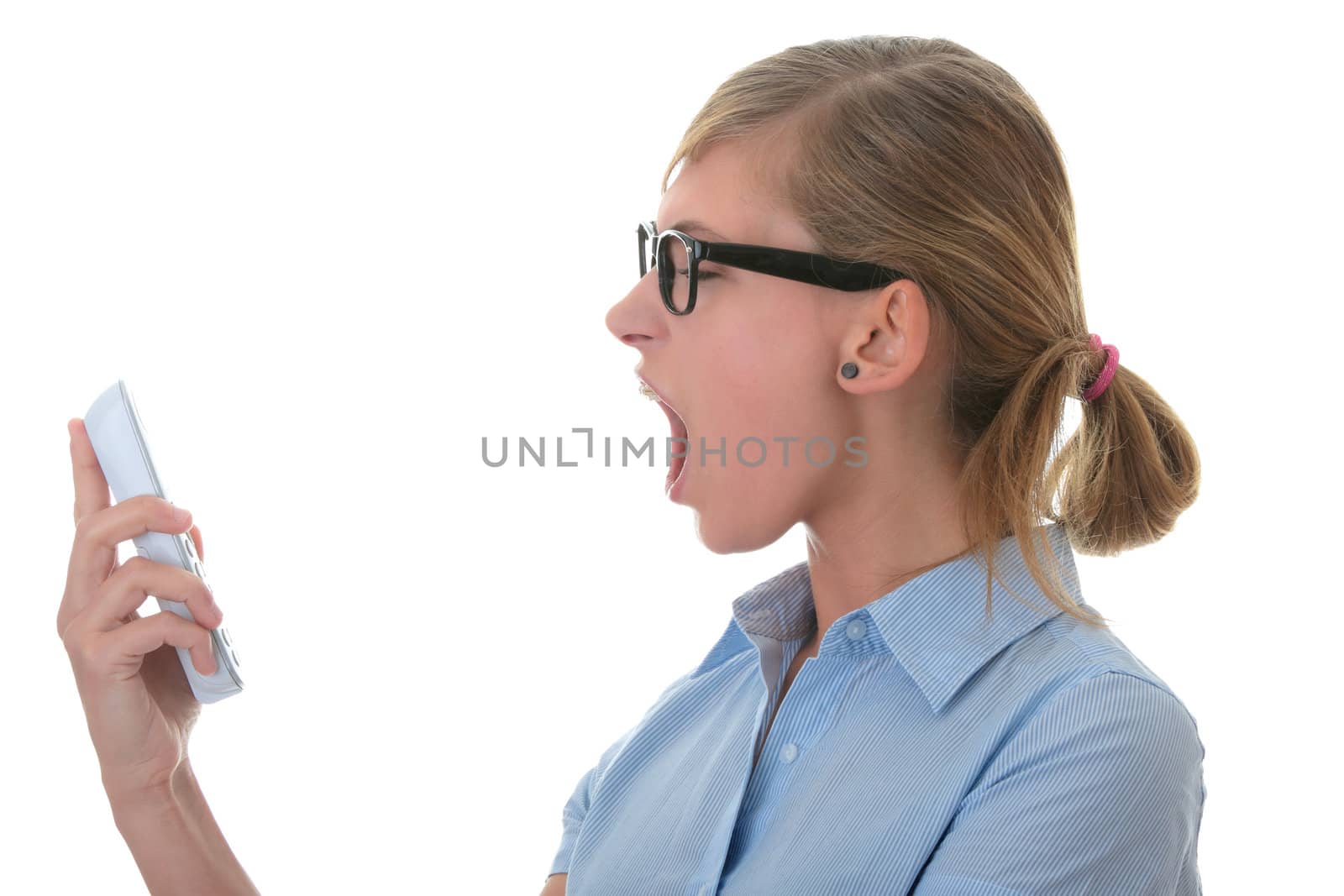 Portrait of a thoughtful young woman in blue shirt and glasses shouting to phone