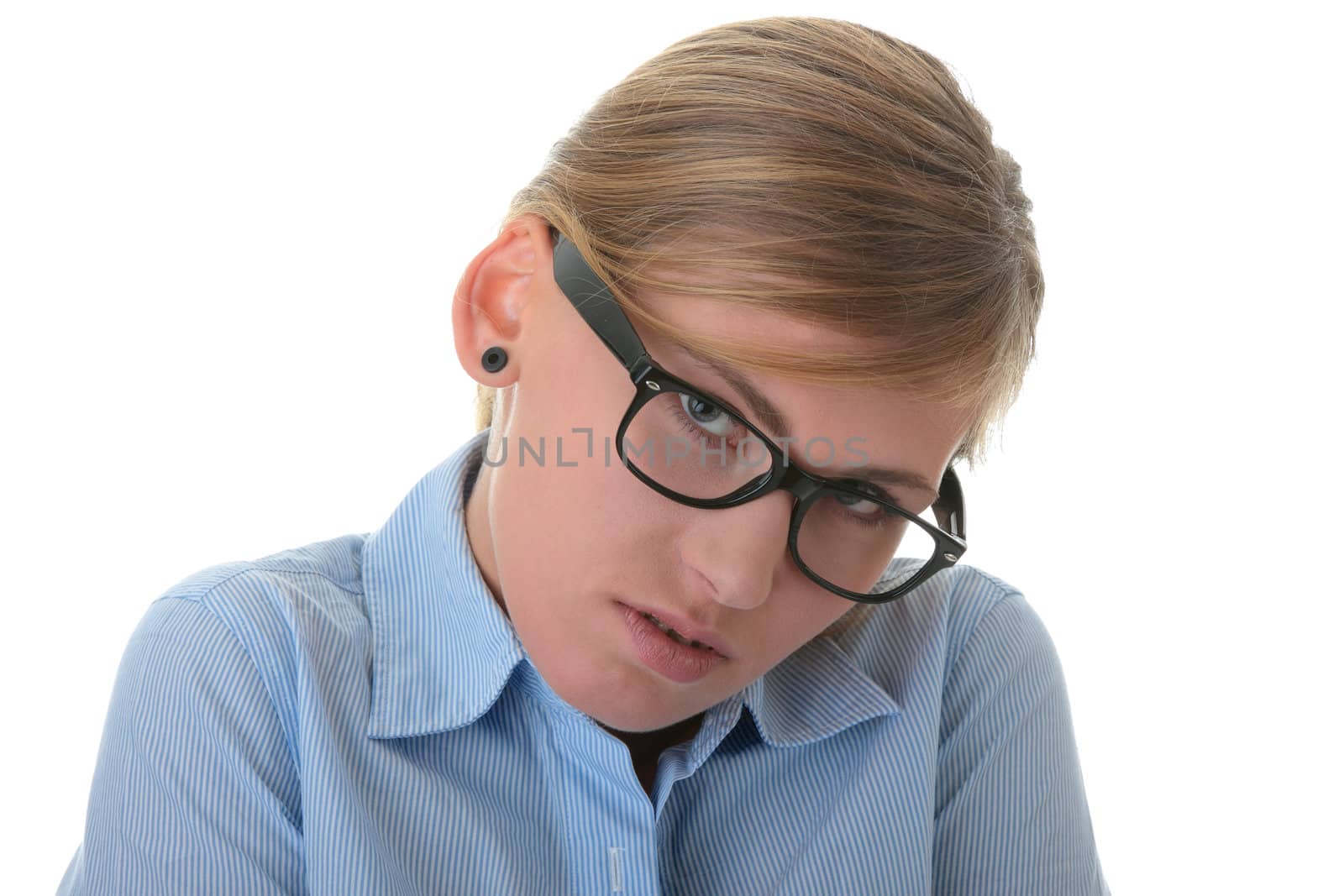 Portrait of a thoughtful young woman in blue shirt and glasses (student, secretary or businesswoman)