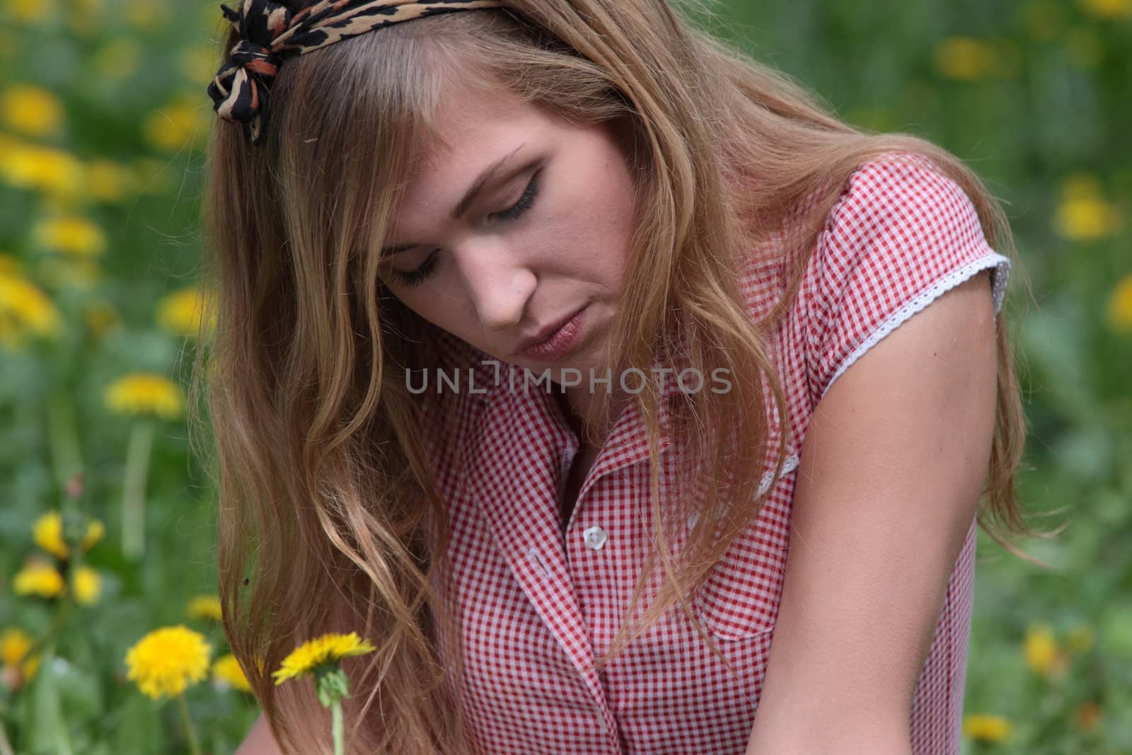 Beautiful woman relaxing in the grass and flowers by BDS