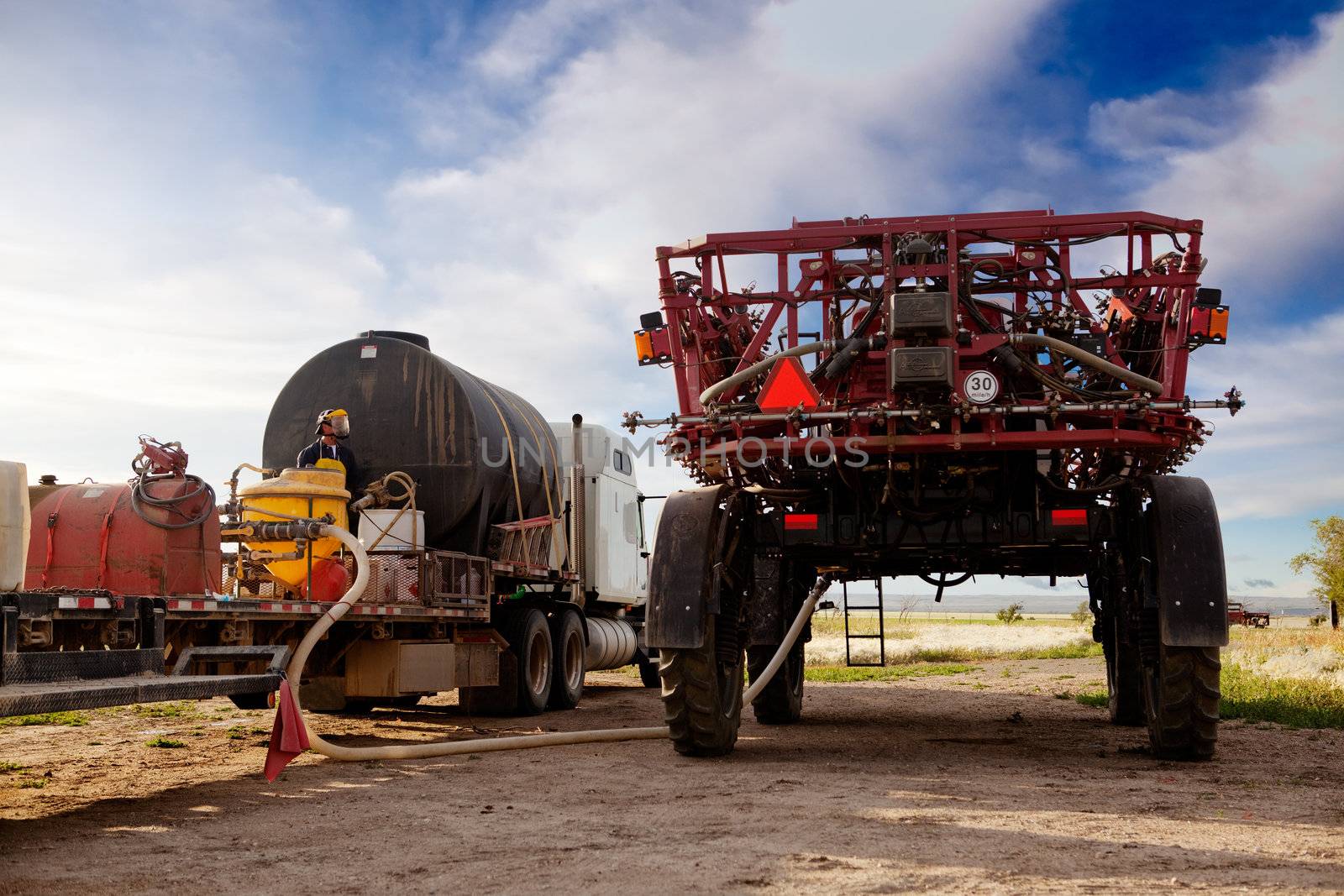 A high clearance spraying being filled with chemical and water