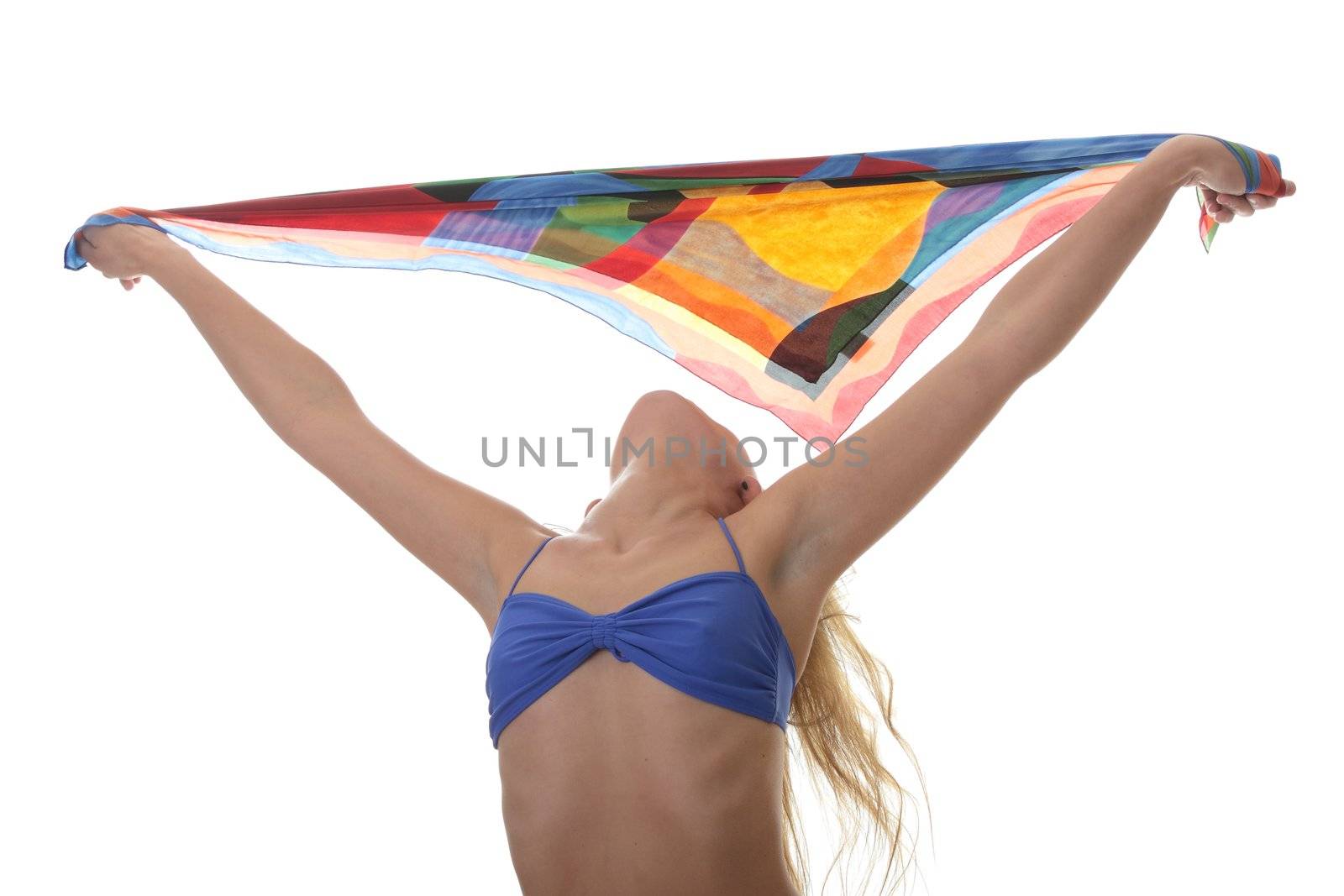 A beautiful young blond woman wearing a blue bikini with colorfull material blowing in the wind isolated on white background