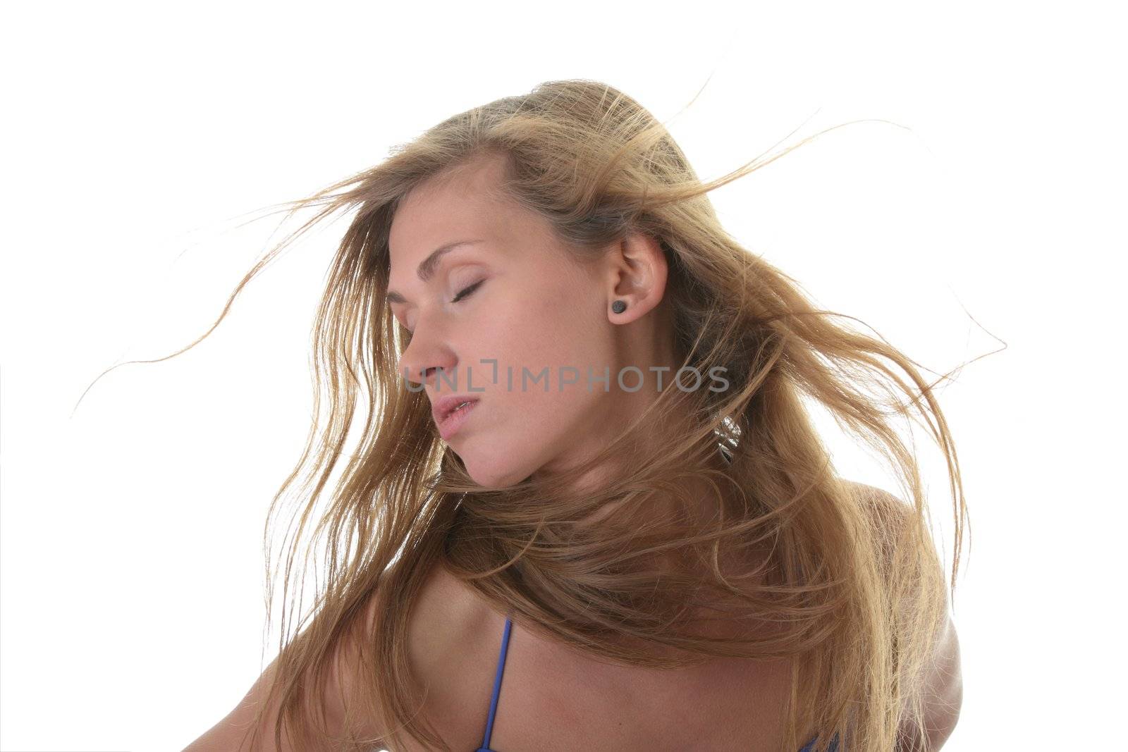 A beautiful young blond woman wearing a blue bikini her hairs blowing in the wind isolated on white background