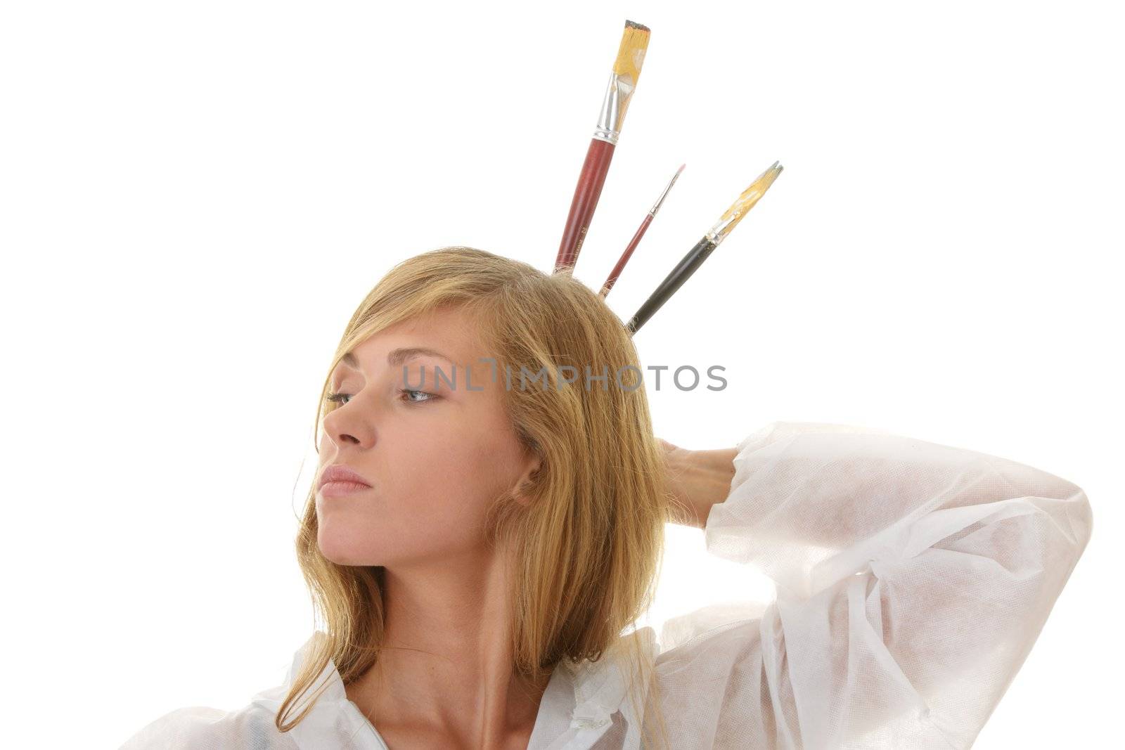 A female blond artist in white uniform with brushes - painting