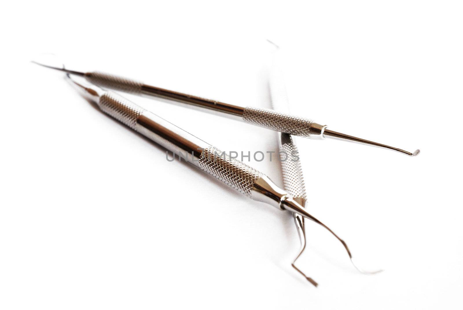 three dentist tools isolated against white baground
